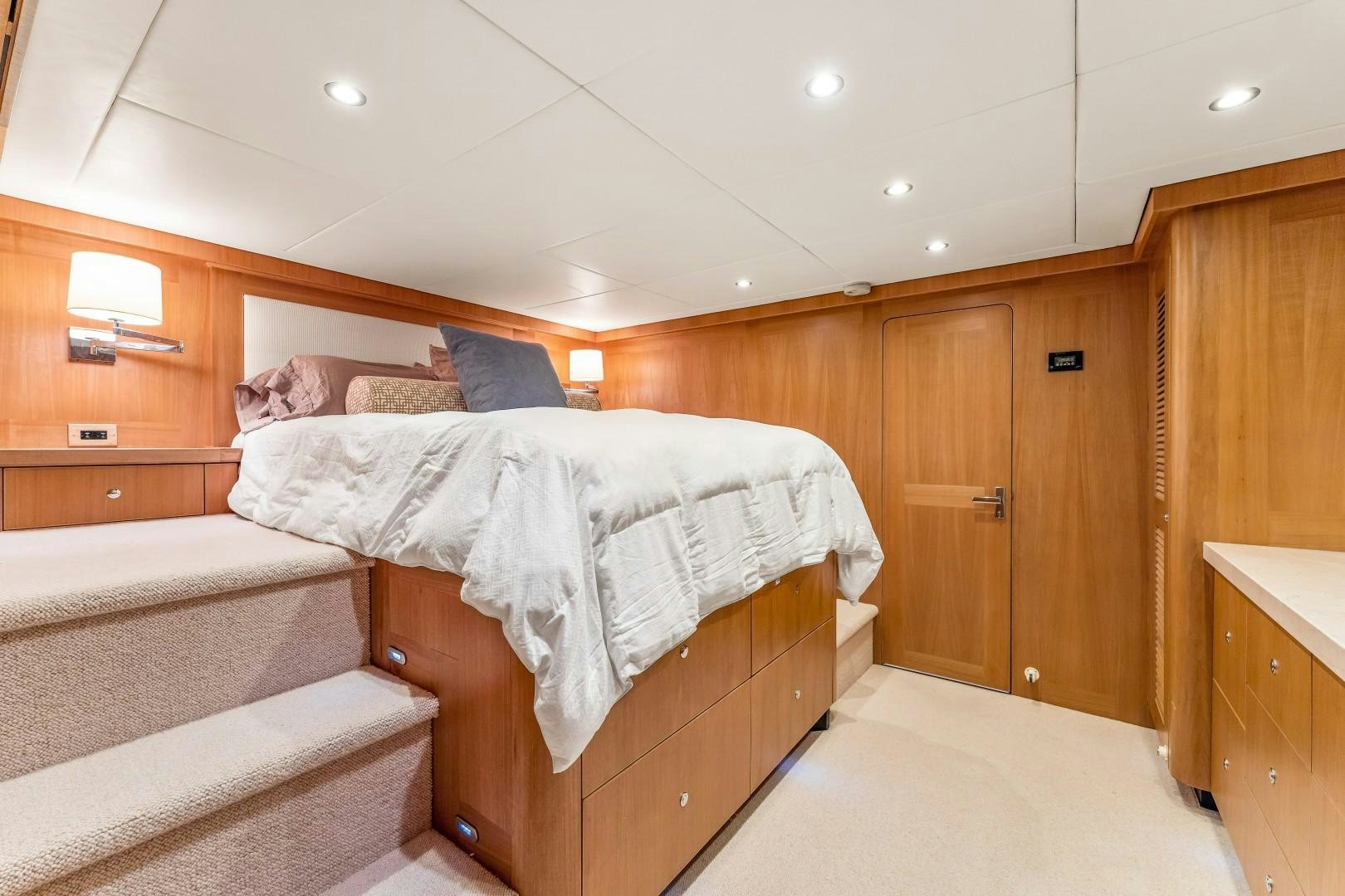 a room with wooden cabinets and a couple of beds aboard No Name Yacht for Sale