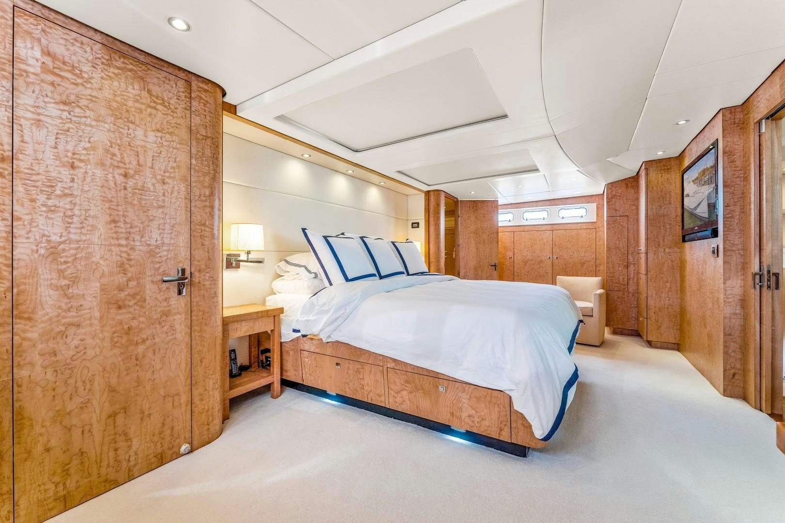 a bedroom with a bed and a wood wall aboard No Name Yacht for Sale