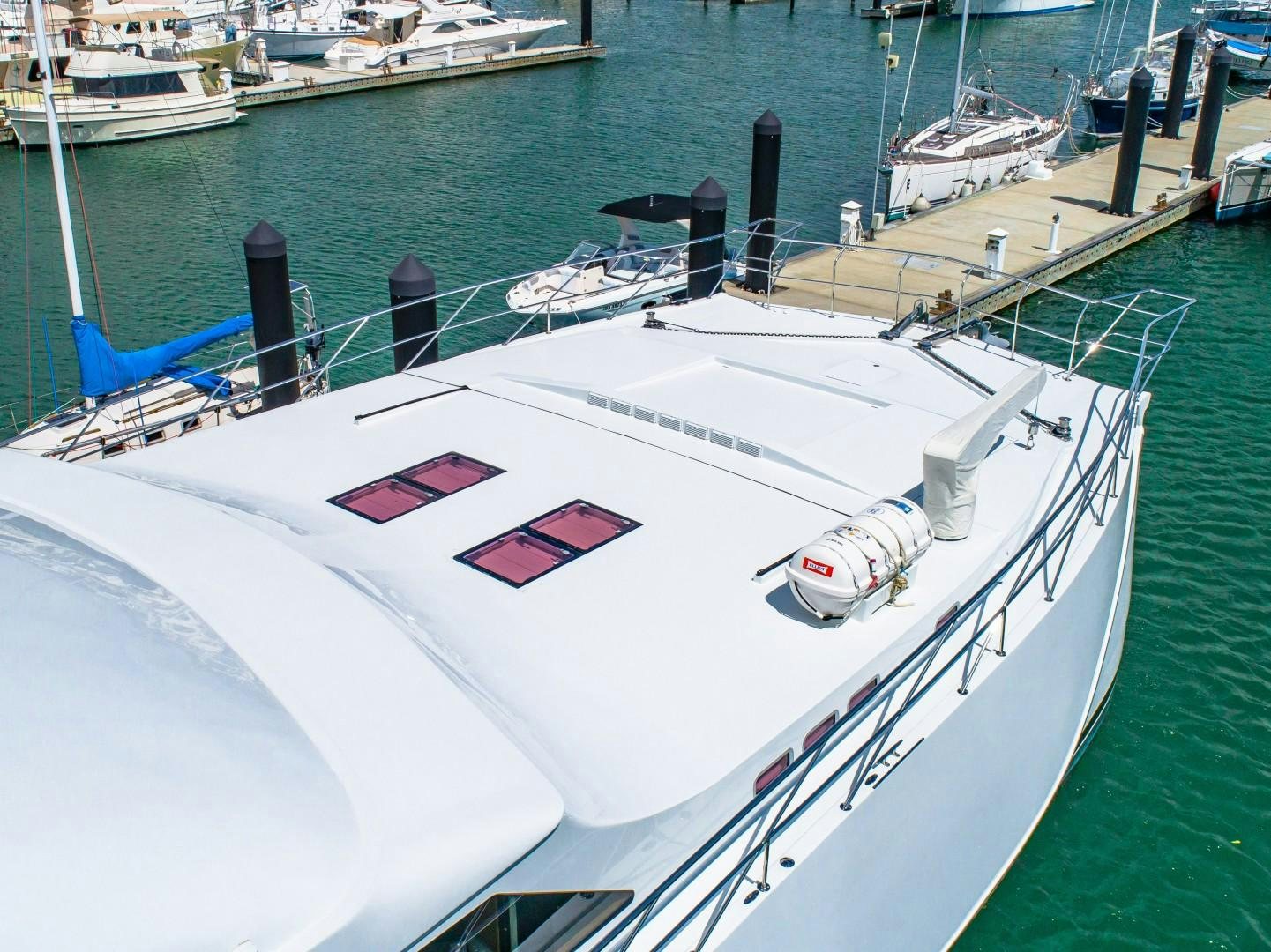 a white boat in a harbor aboard No Name Yacht for Sale