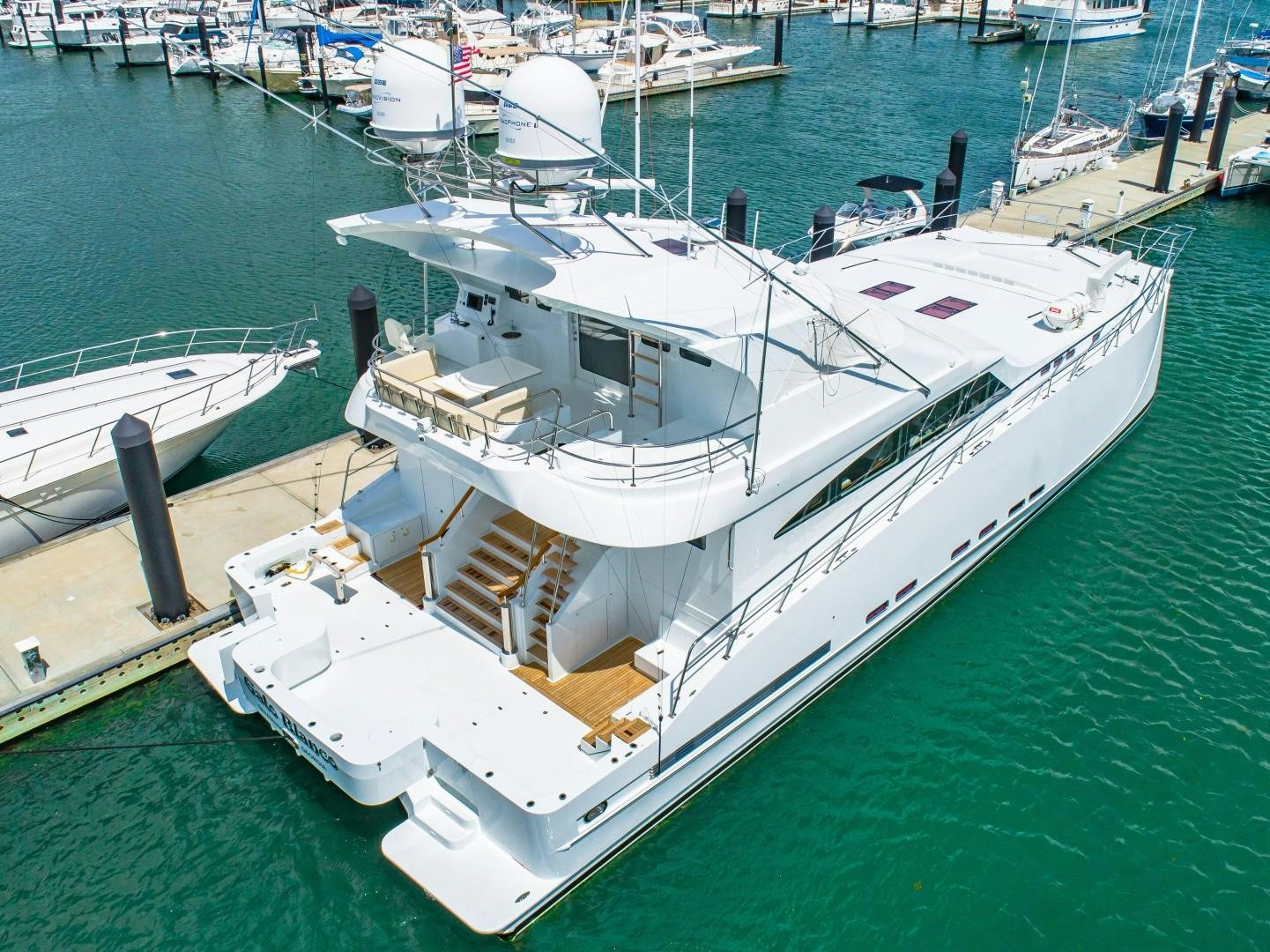 a large white boat in a harbor aboard No Name Yacht for Sale