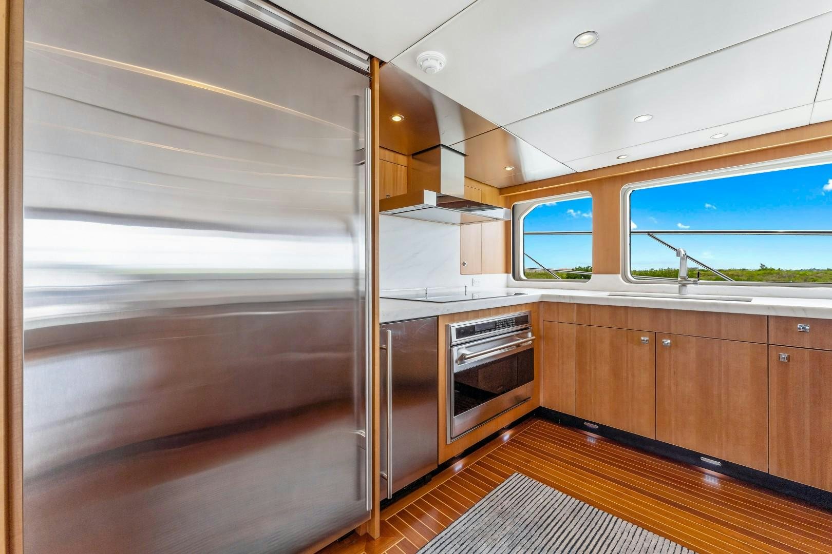 a room with wooden cabinets aboard No Name Yacht for Sale