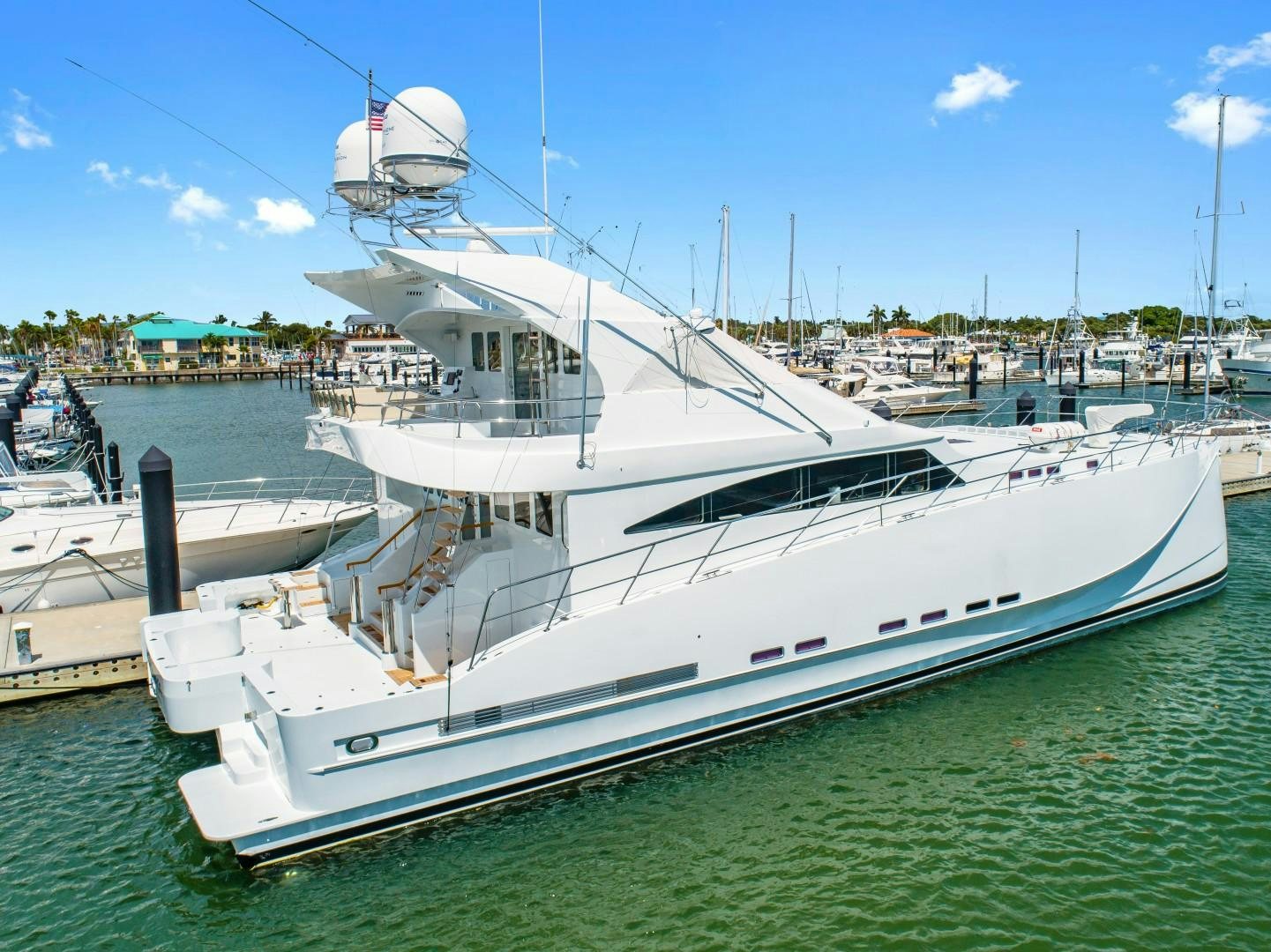 a white boat in a harbor aboard No Name Yacht for Sale