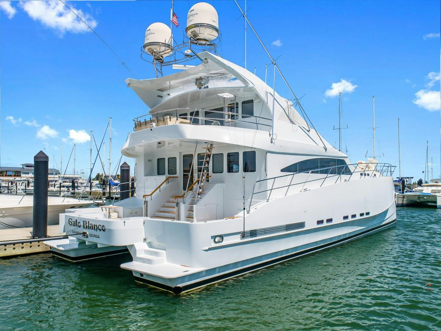 a large white boat docked aboard No Name Yacht for Sale