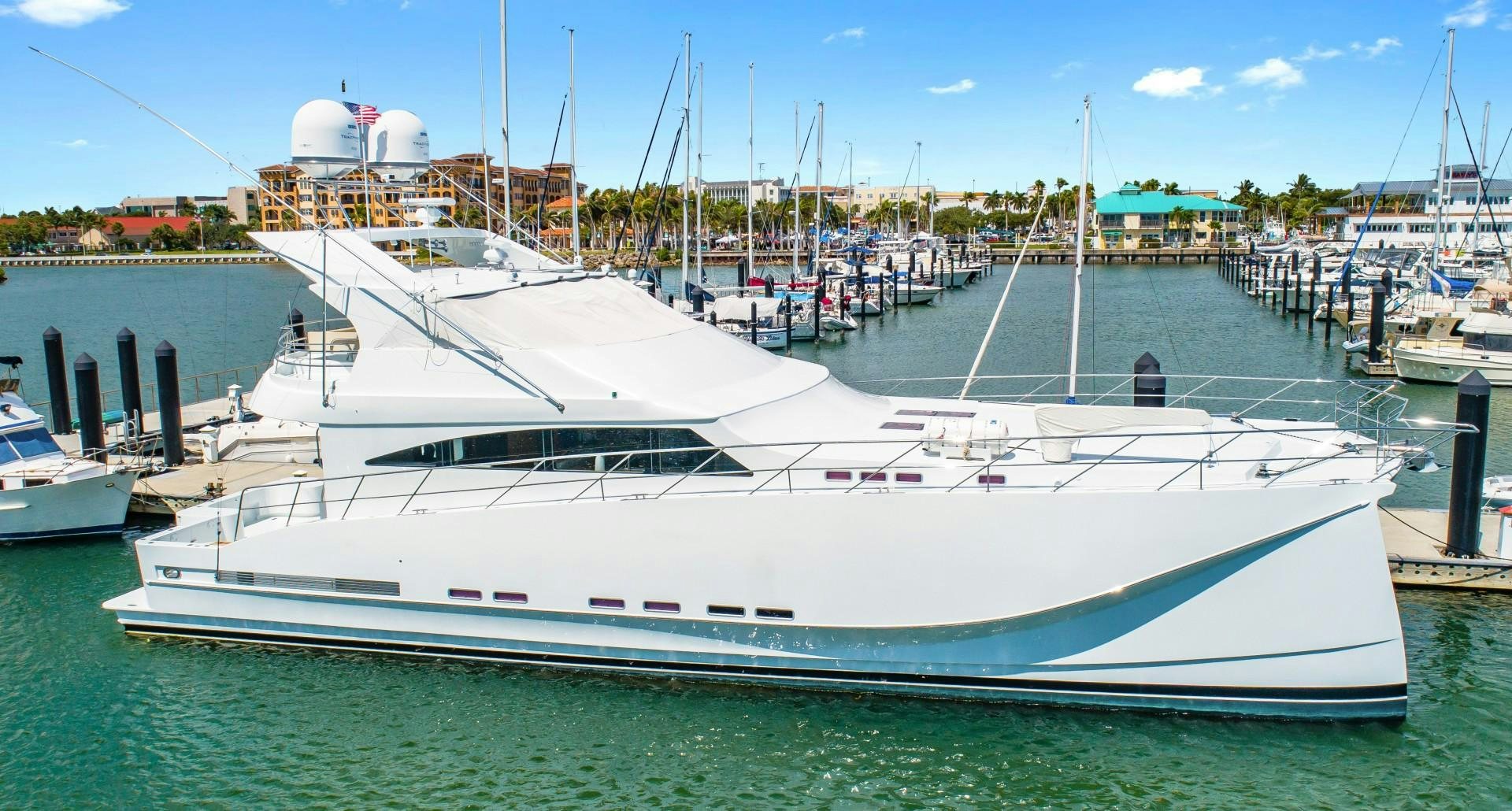 a large white yacht docked at a pier aboard No Name Yacht for Sale
