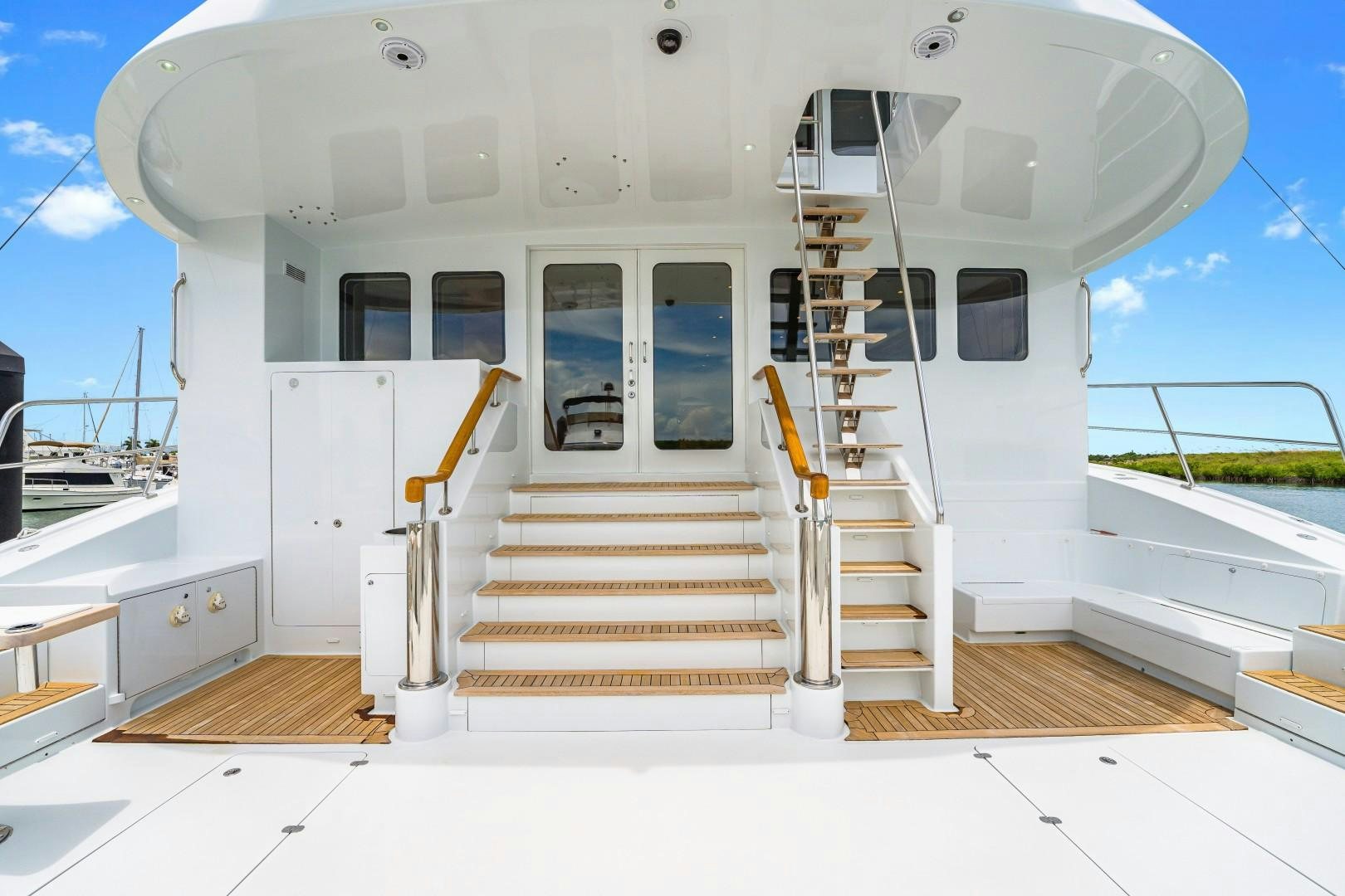 a white boat with a deck aboard No Name Yacht for Sale