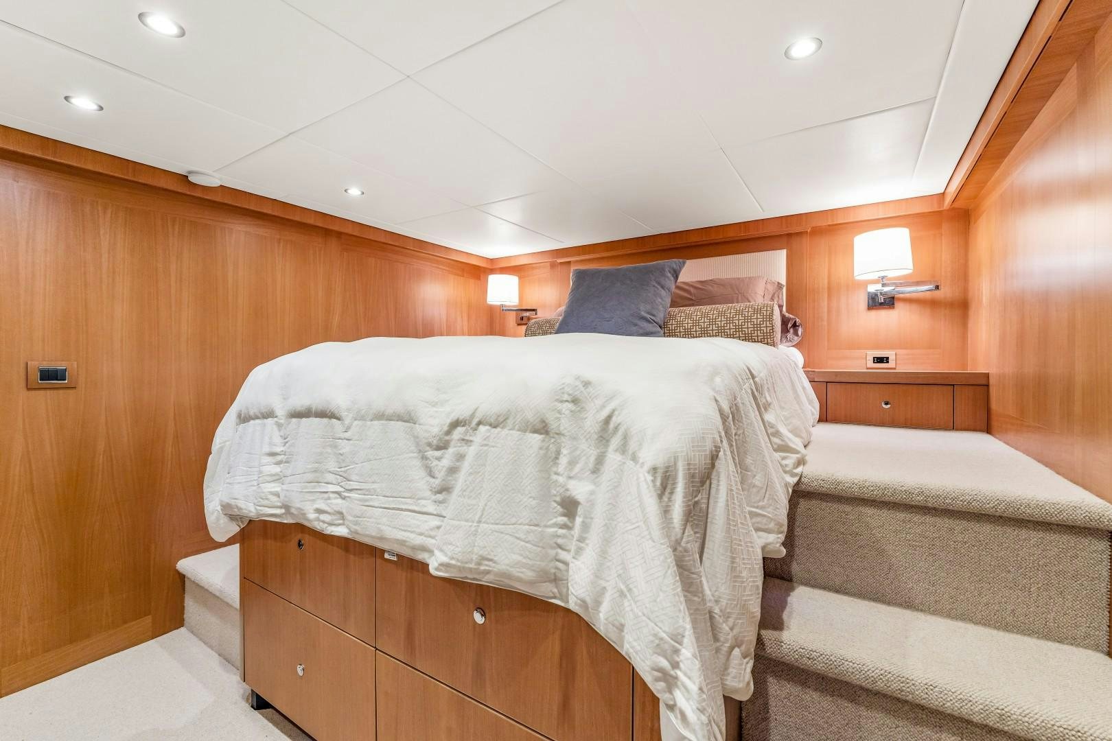 a room with a bed and a wood wall aboard No Name Yacht for Sale