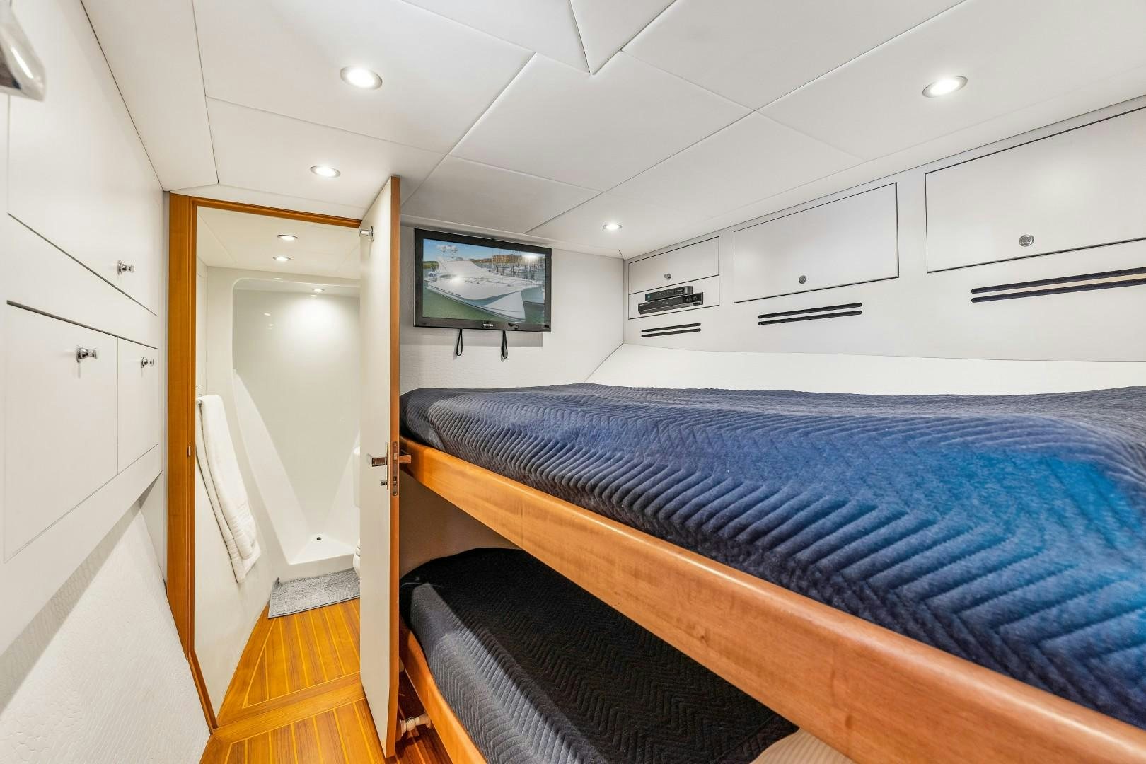 a bedroom with a bed and cabinets aboard No Name Yacht for Sale