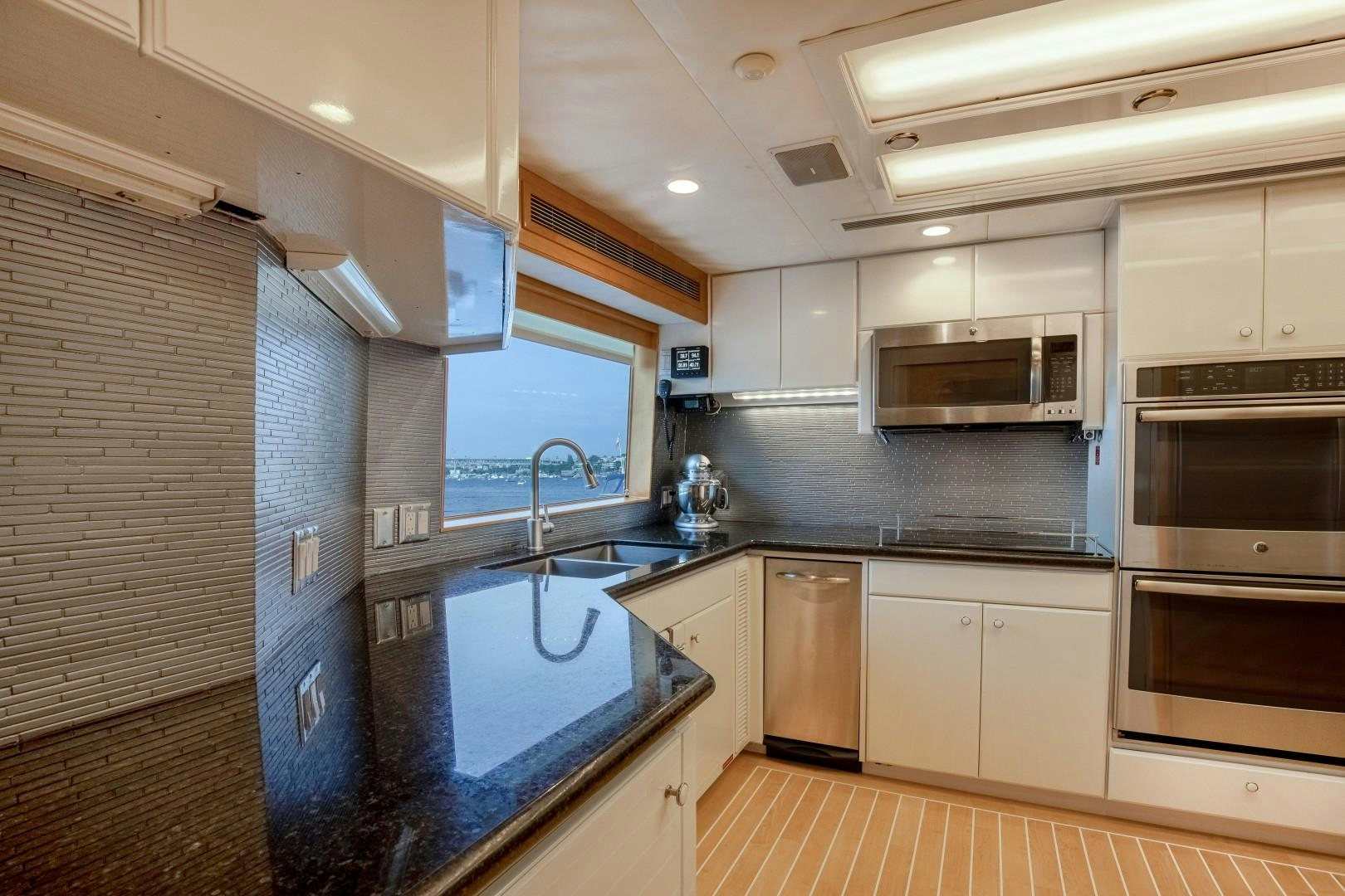 a kitchen with white cabinets aboard SINBAD Yacht for Sale
