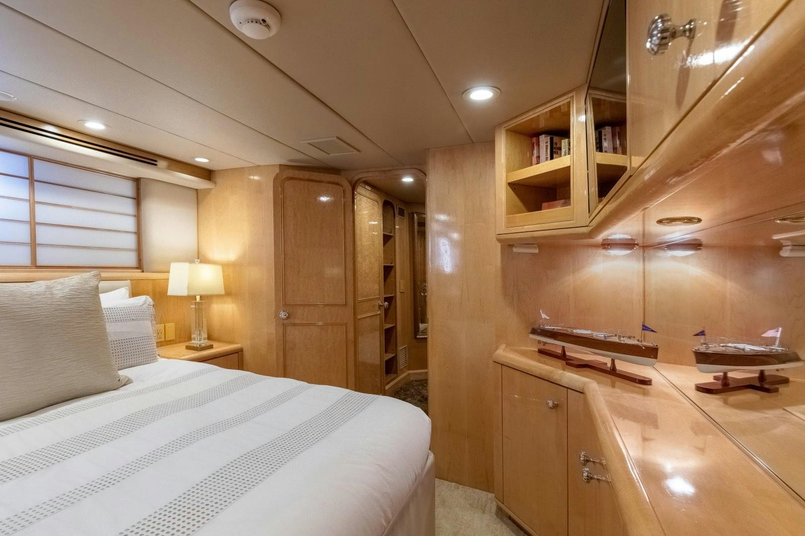 a bedroom with a bed and a desk aboard SINBAD Yacht for Sale