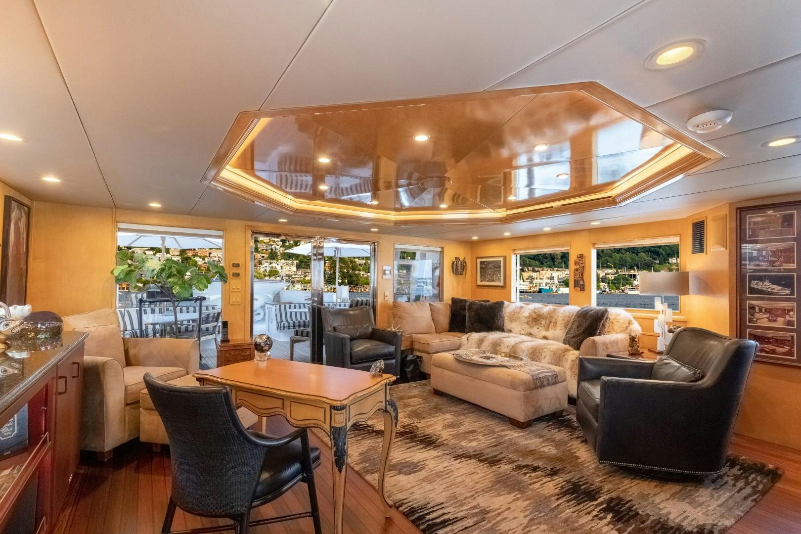 a living room with leather couches and a table aboard SINBAD Yacht for Sale