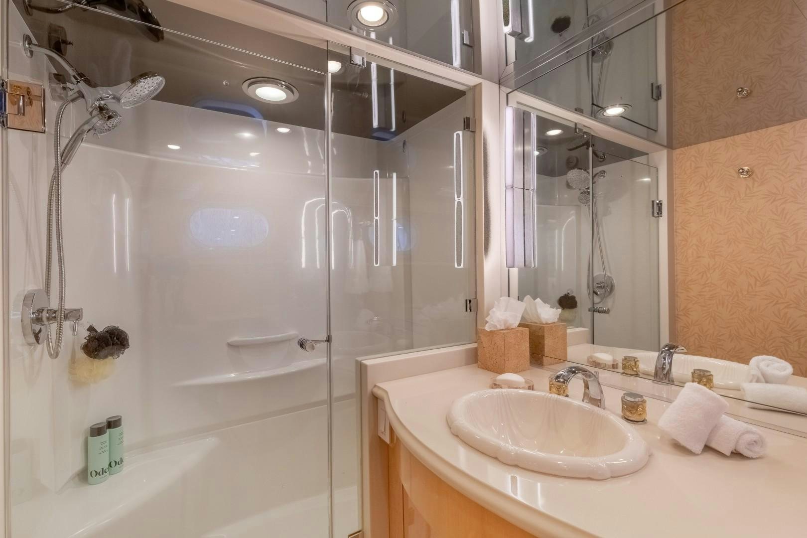 a bathroom with a shower sink and a mirror aboard SINBAD Yacht for Sale