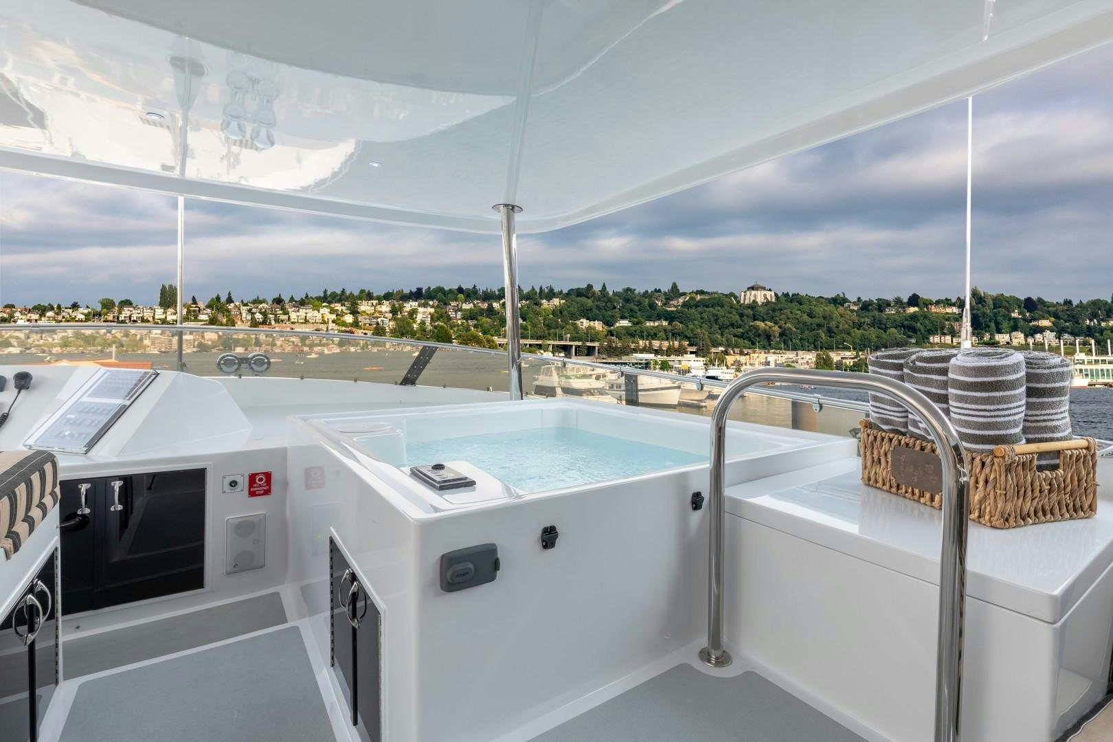 a large white kitchen with a large window and a view of the city aboard SINBAD Yacht for Sale