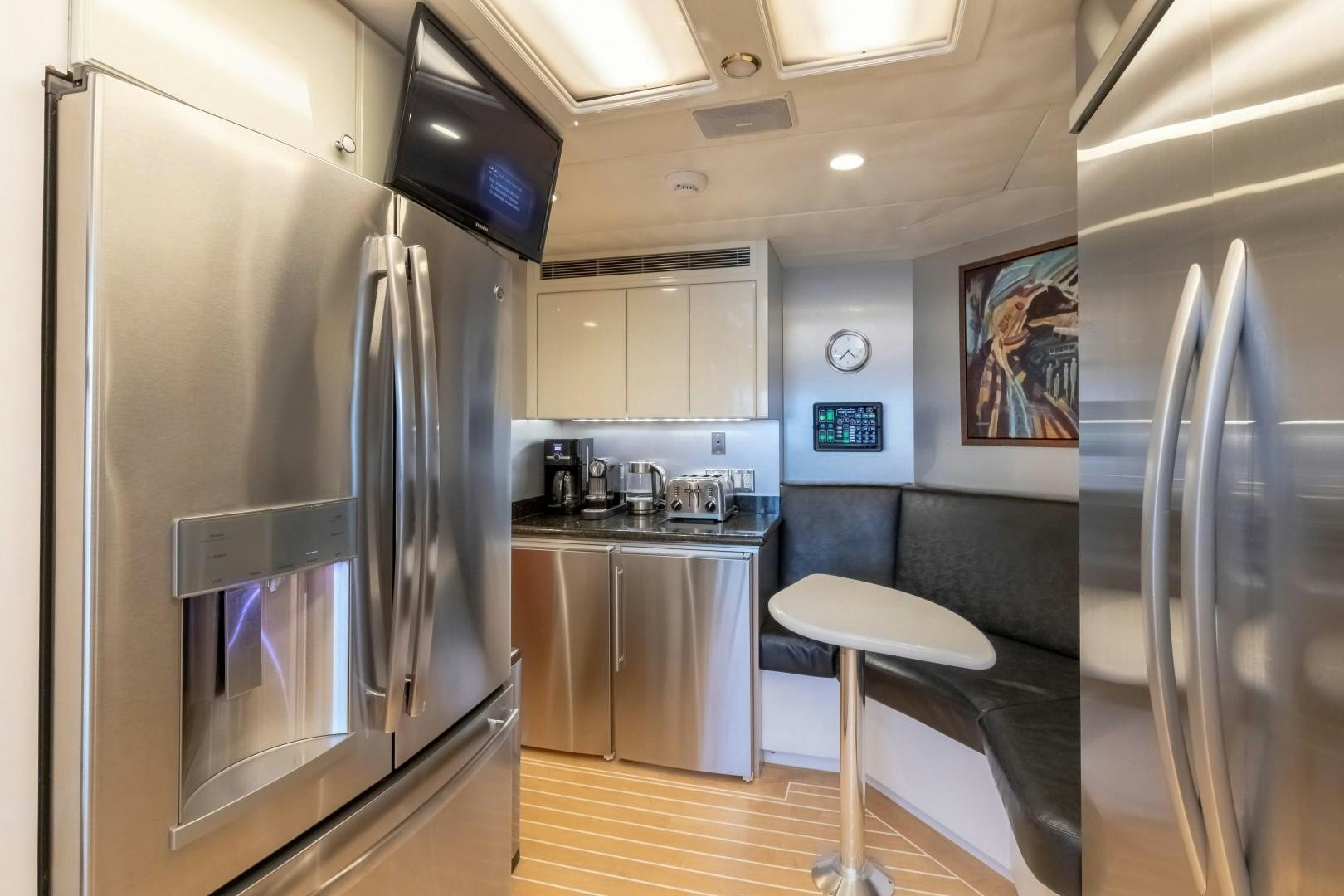 a kitchen with a stainless steel refrigerator aboard SINBAD Yacht for Sale