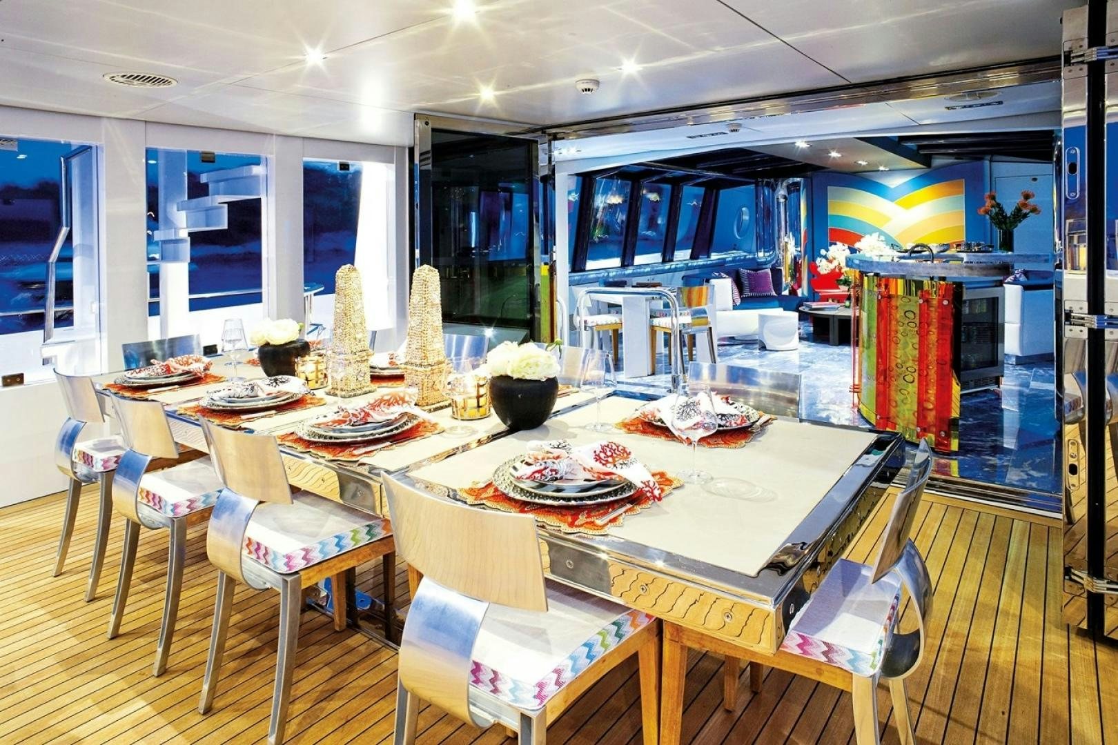 a large kitchen with a table set aboard HIGHLANDER Yacht for Sale
