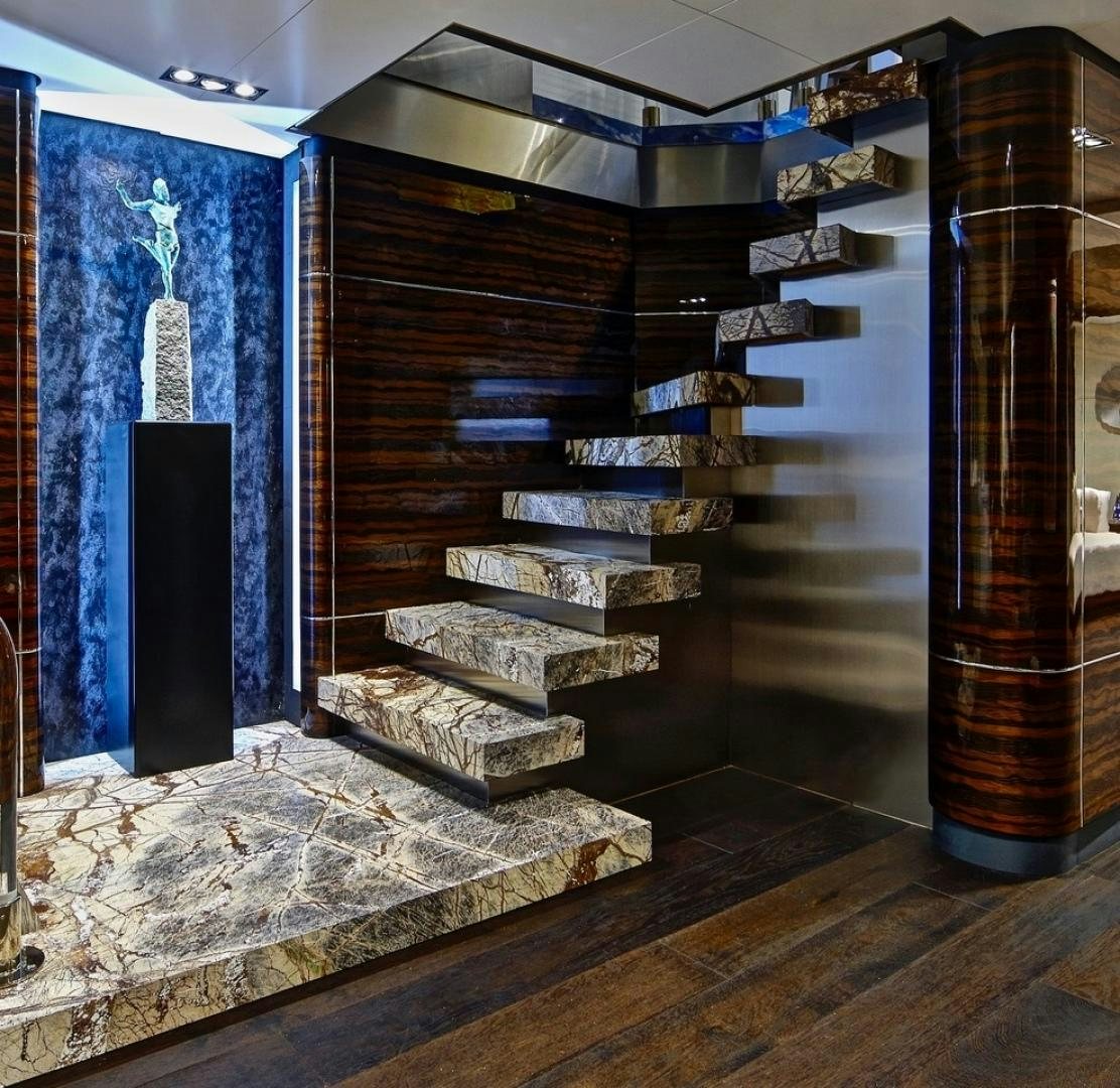 a room with a wood staircase aboard HIGHLANDER Yacht for Sale