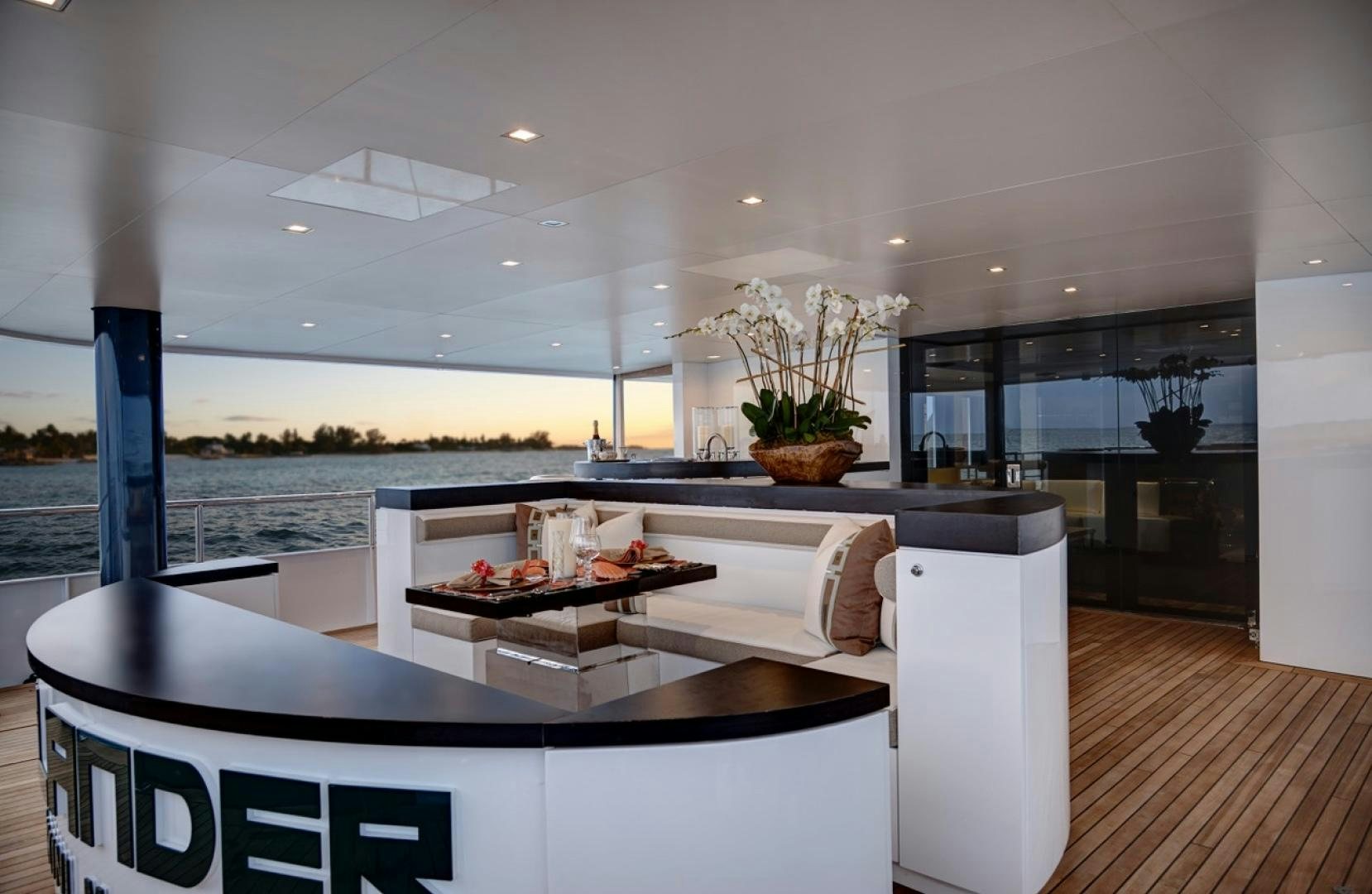 a modern kitchen with white cabinets aboard HIGHLANDER Yacht for Sale