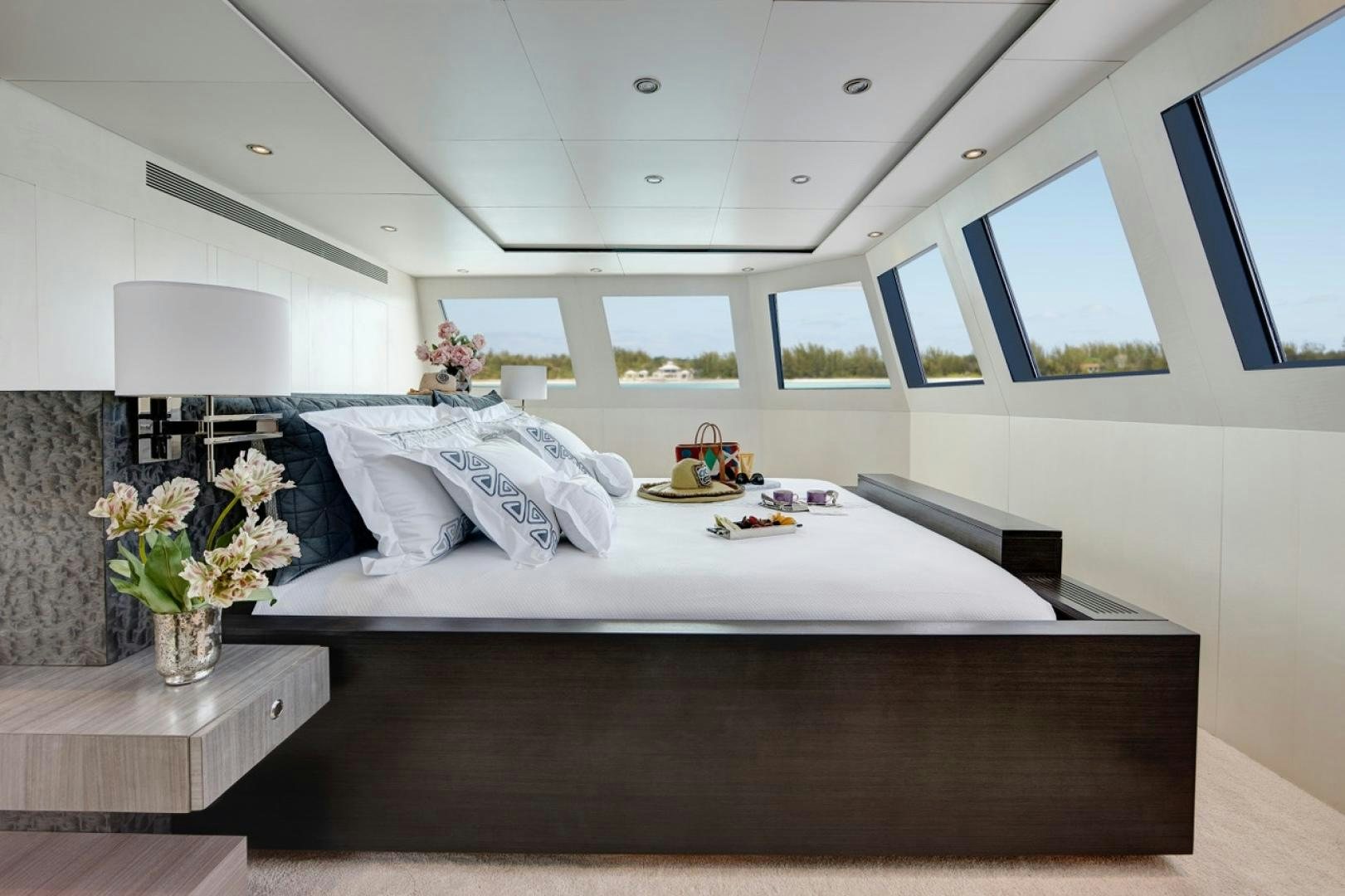 a bed with white sheets and pillows aboard HIGHLANDER Yacht for Sale