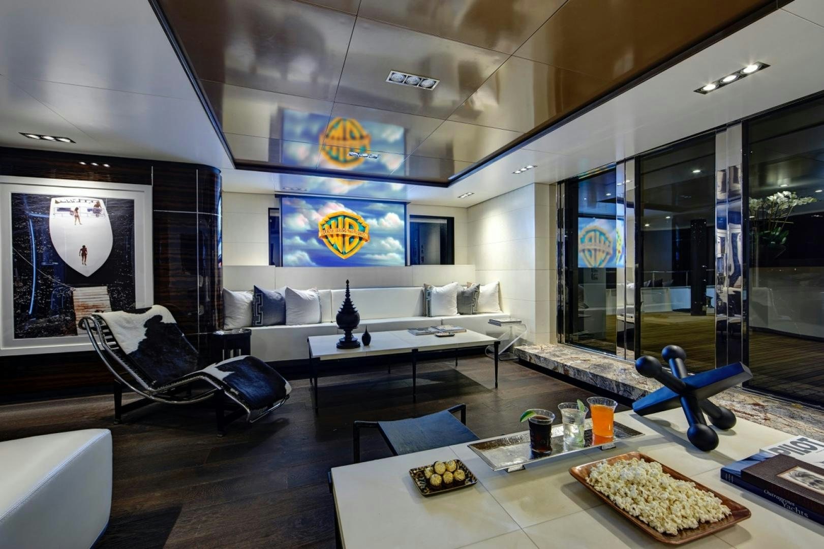 a room with a table chairs and a couch aboard HIGHLANDER Yacht for Sale