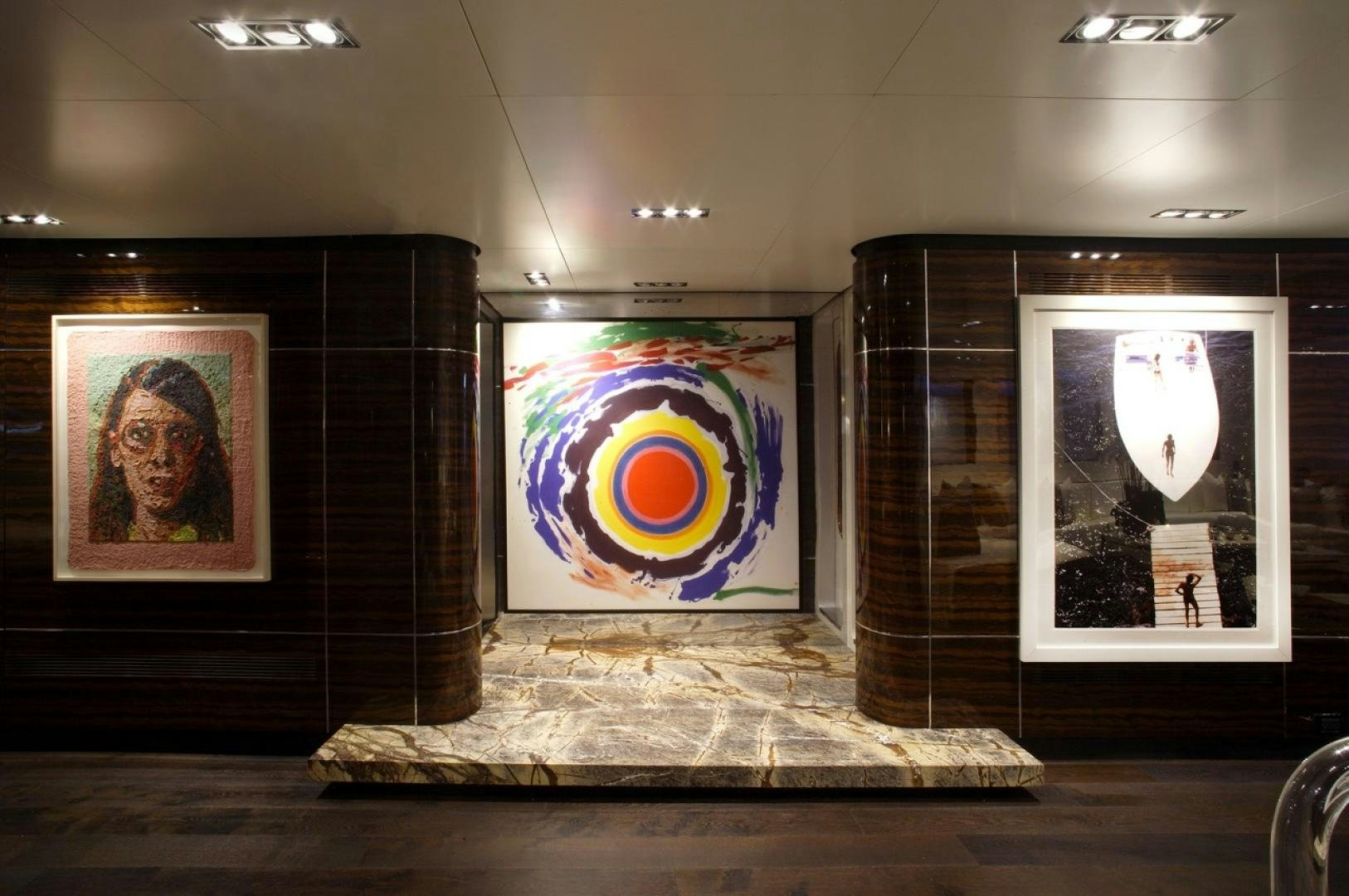 a room with paintings on the wall aboard HIGHLANDER Yacht for Sale