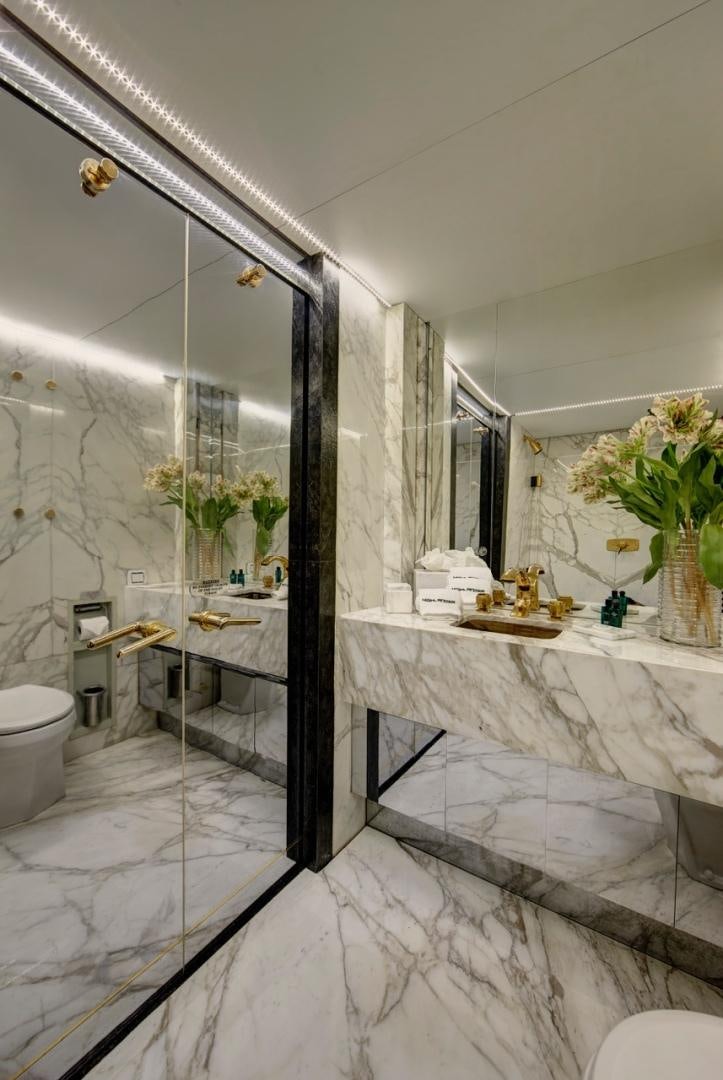 a bathroom with a large mirror aboard HIGHLANDER Yacht for Sale