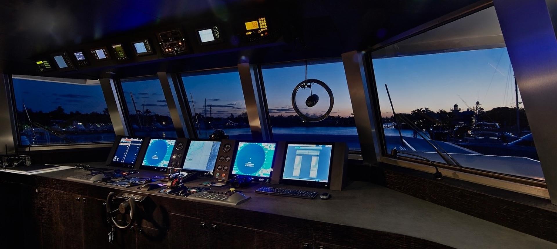 a row of monitors on a desk aboard HIGHLANDER Yacht for Sale