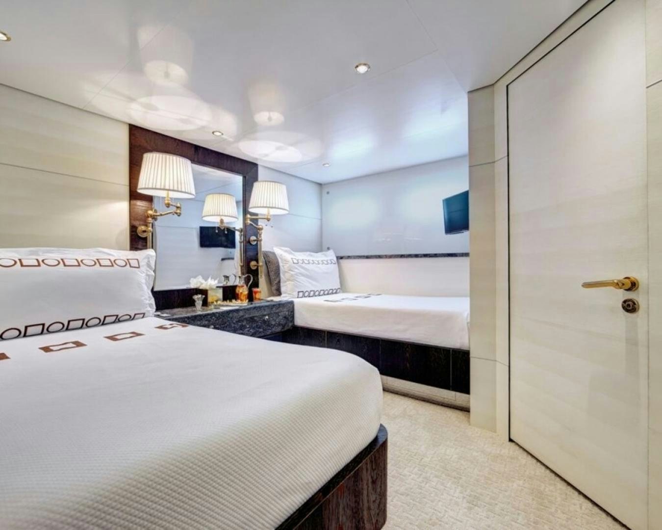 a room with a bed and a television aboard HIGHLANDER Yacht for Sale