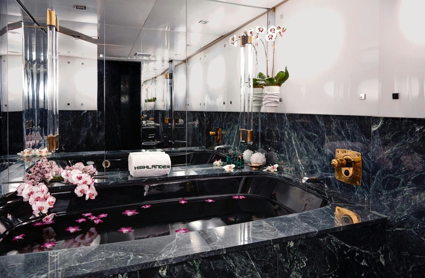 a large bathroom with a large glass shower aboard HIGHLANDER Yacht for Sale