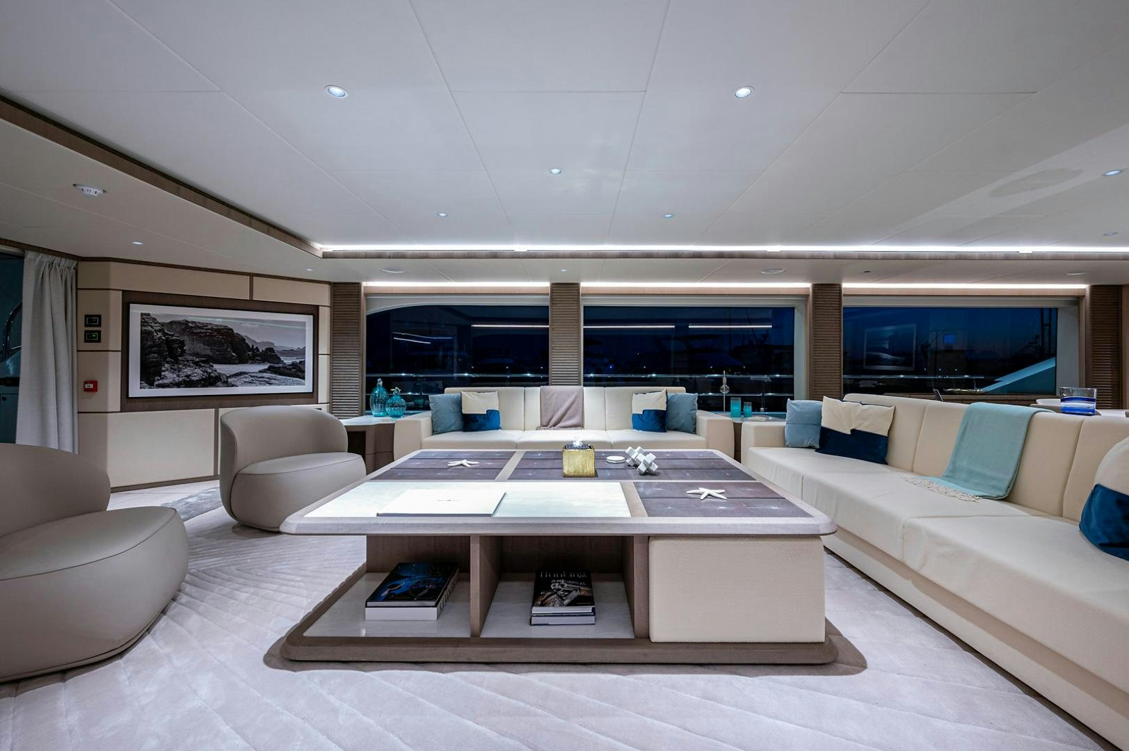 a modern living room with a large open floor plan aboard LIRA Yacht for Sale