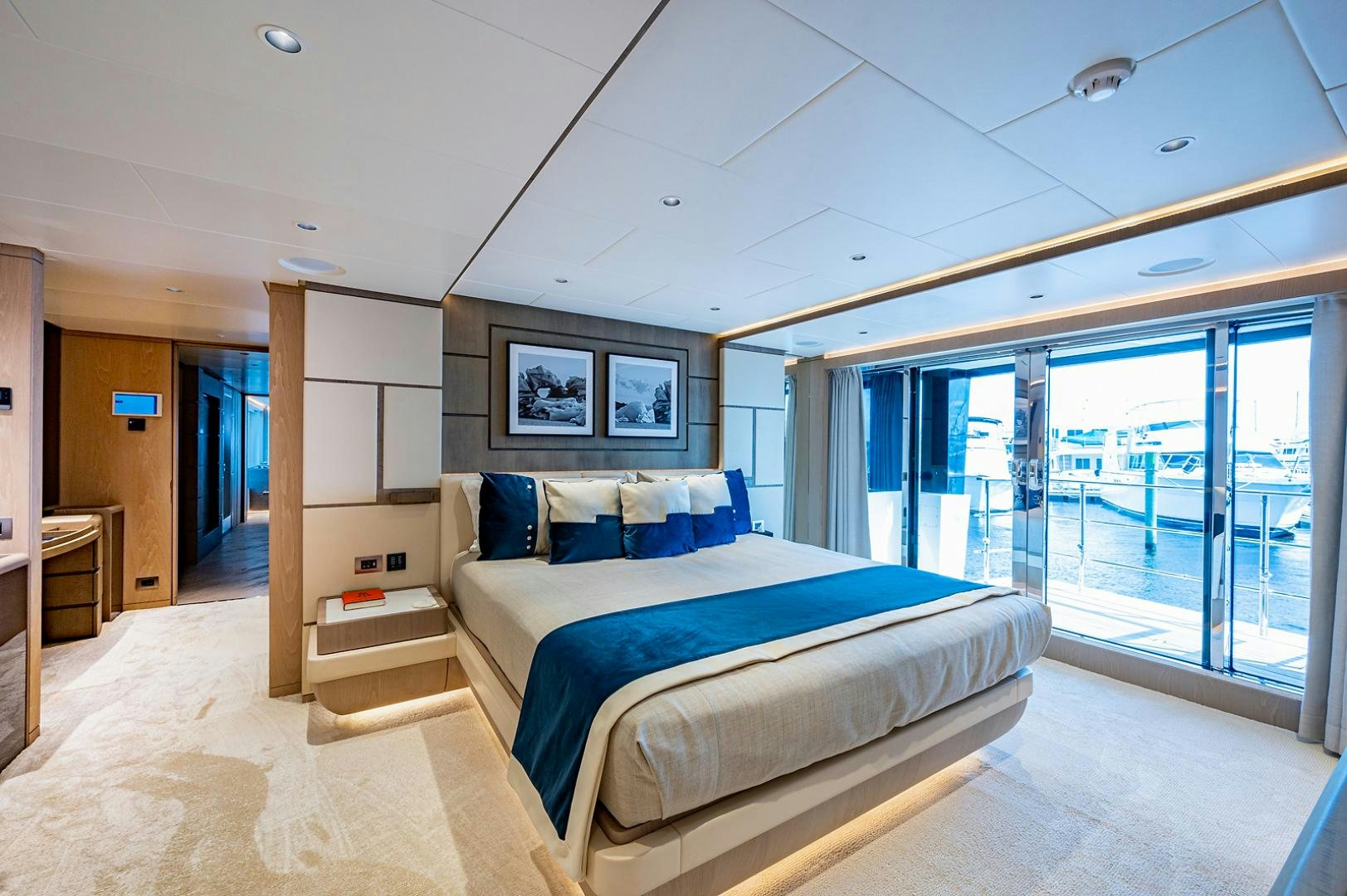 a bedroom with a large glass door aboard LIRA Yacht for Sale