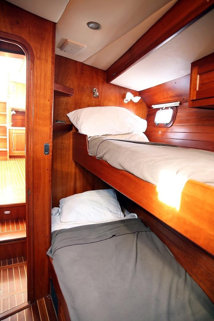 a couple of beds in a room aboard DANCIN BARE V Yacht for Sale