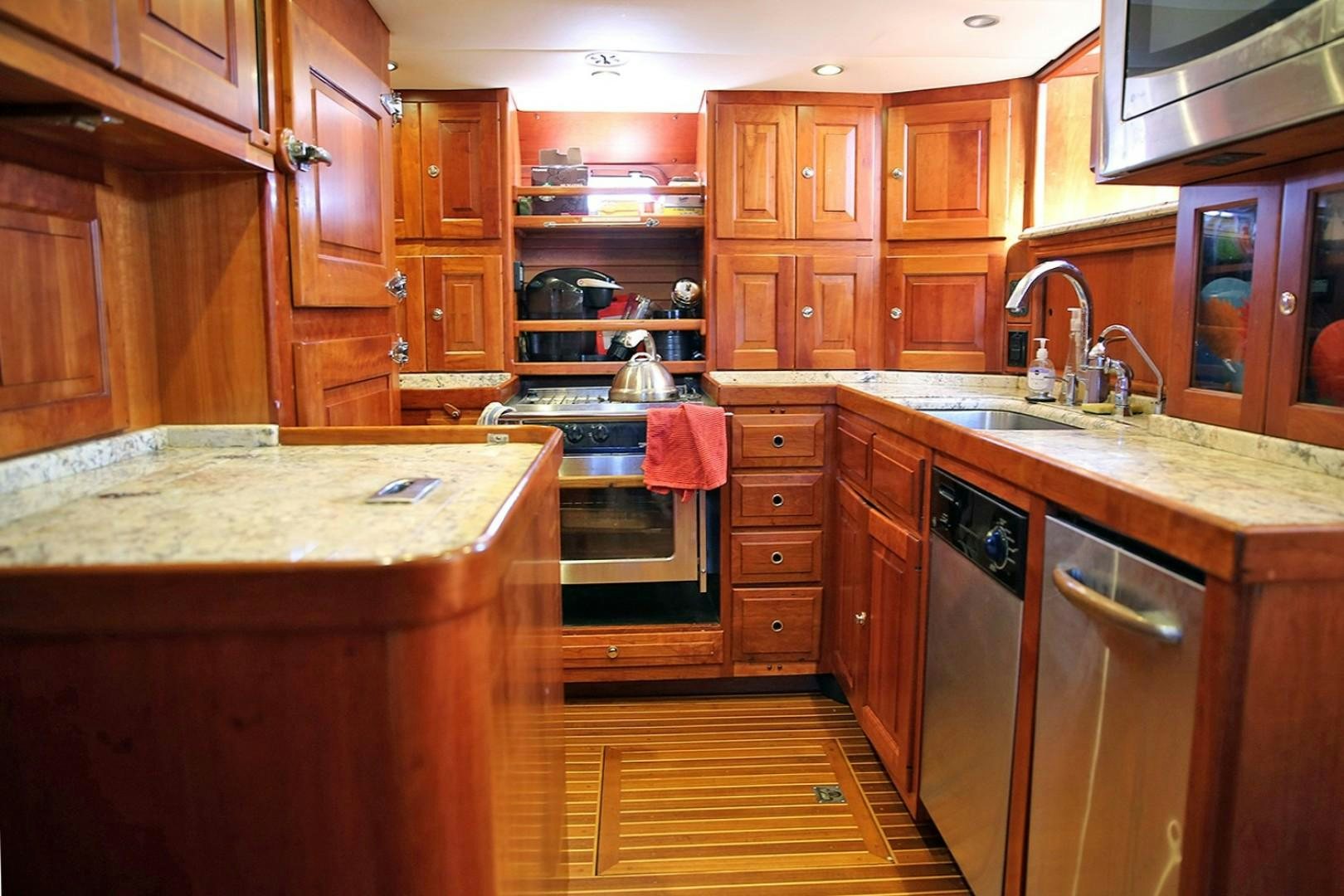 a kitchen with wooden cabinets aboard DANCIN BARE V Yacht for Sale