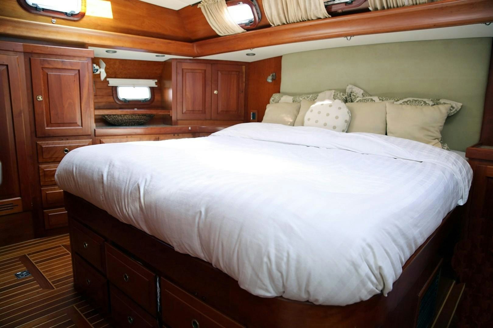 a bed with white sheets aboard DANCIN BARE V Yacht for Sale
