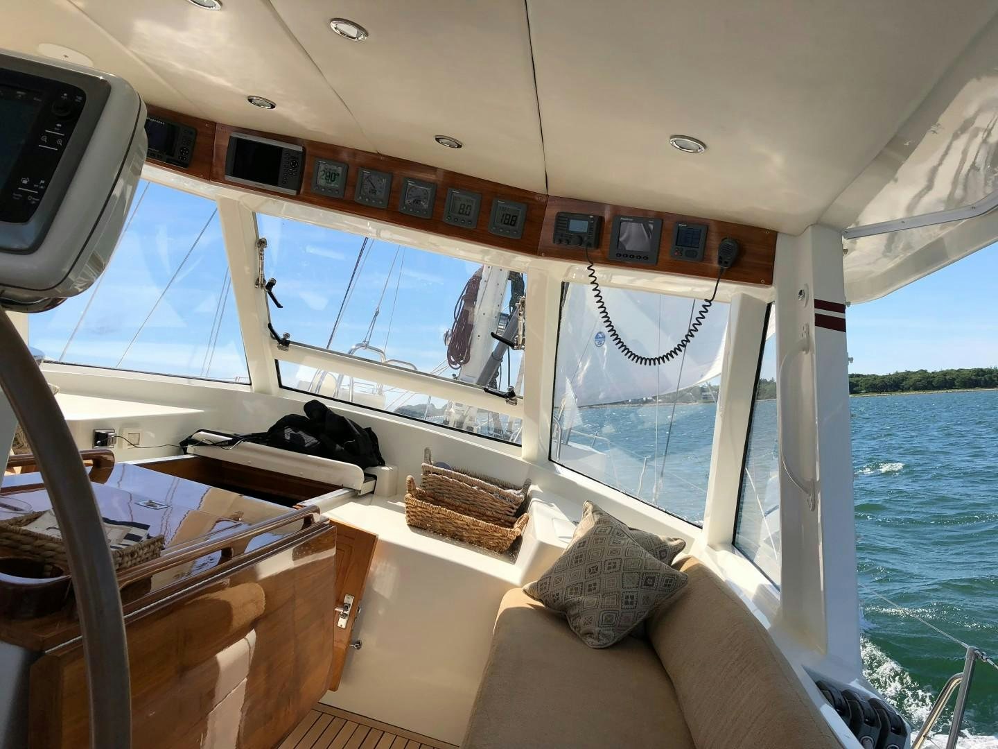 a boat with a seat and pillows aboard DANCIN BARE V Yacht for Sale