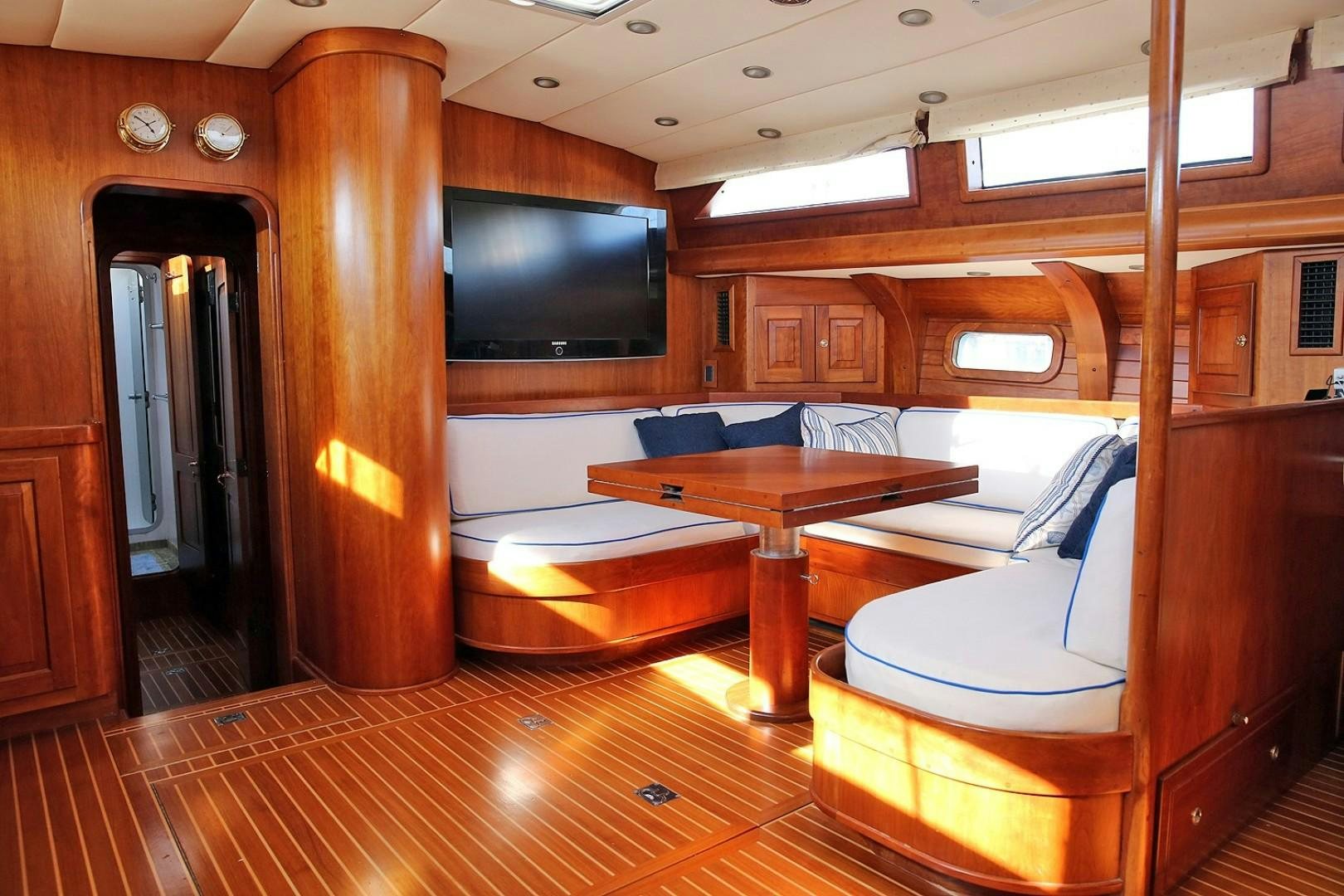 a room with a table and chairs aboard DANCIN BARE V Yacht for Sale