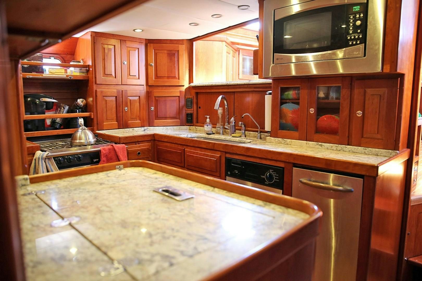 a kitchen with wooden cabinets aboard DANCIN BARE V Yacht for Sale