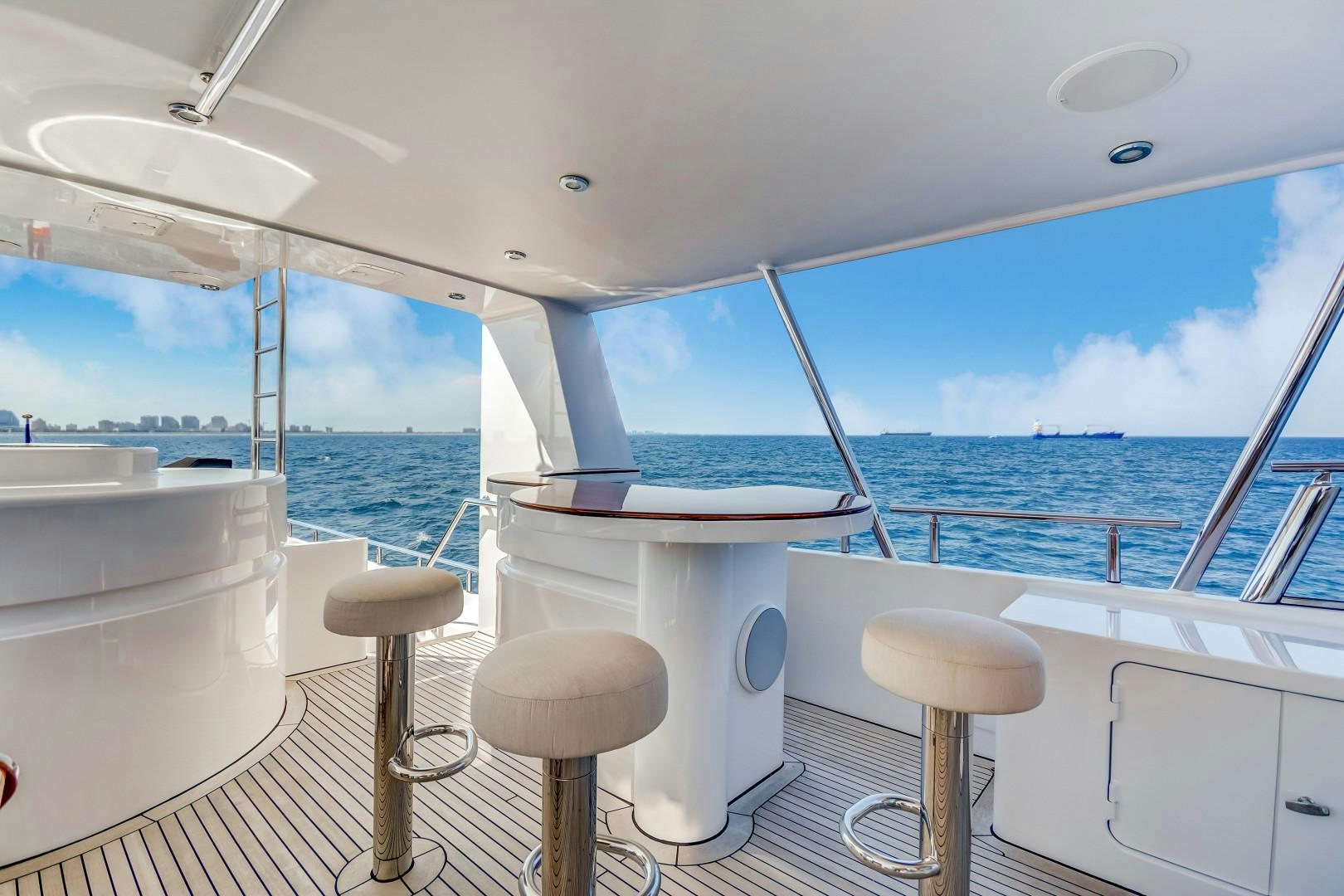 a boat with stools and stools on the deck aboard GUSTO Yacht for Sale