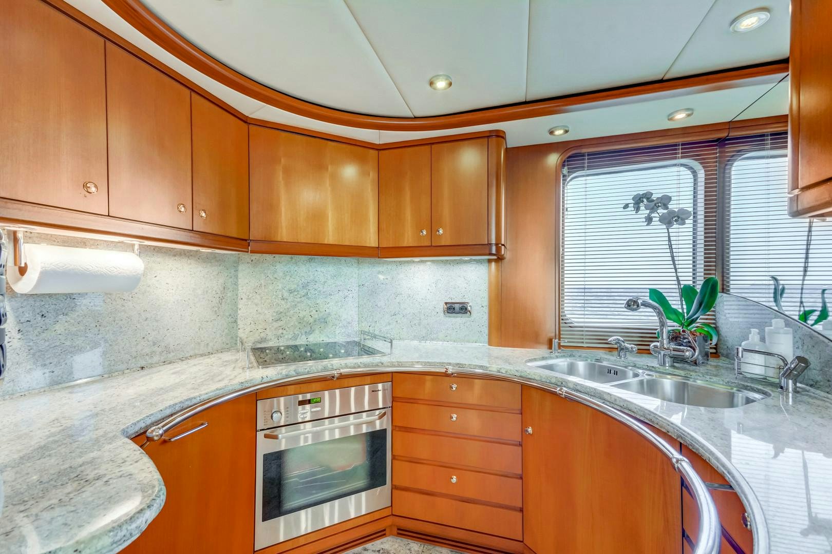 a kitchen with wooden cabinets aboard GUSTO Yacht for Sale