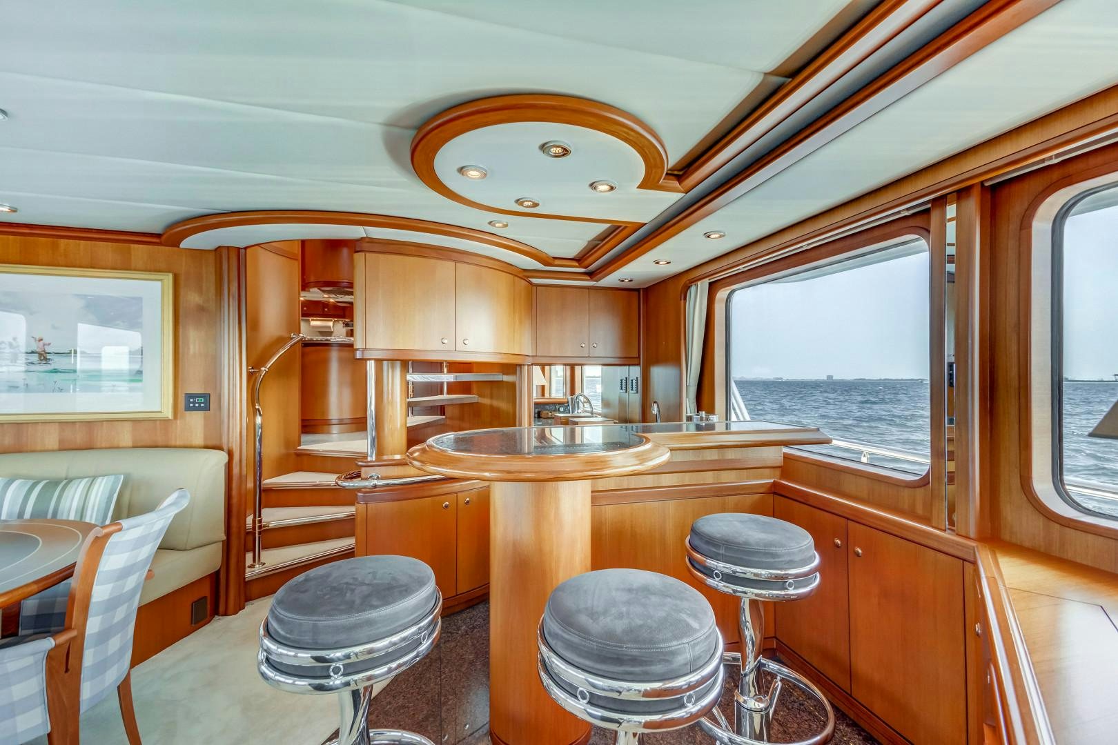 a kitchen with a bar and stools aboard GUSTO Yacht for Sale