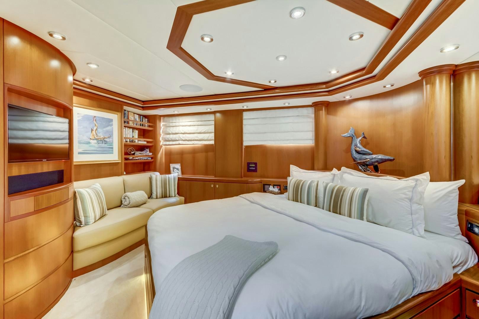 a room with a bed and a couch aboard GUSTO Yacht for Sale