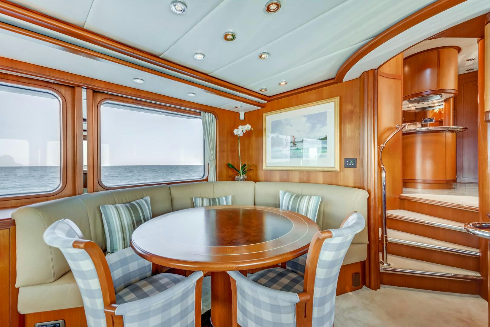 a dining table and chairs in a cabin aboard GUSTO Yacht for Sale