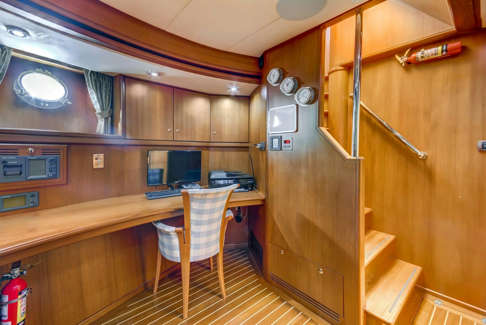 a room with a desk and computer aboard GUSTO Yacht for Sale
