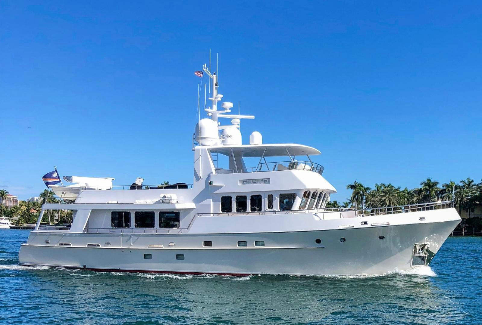 a large white boat in the water aboard GUSTO Yacht for Sale