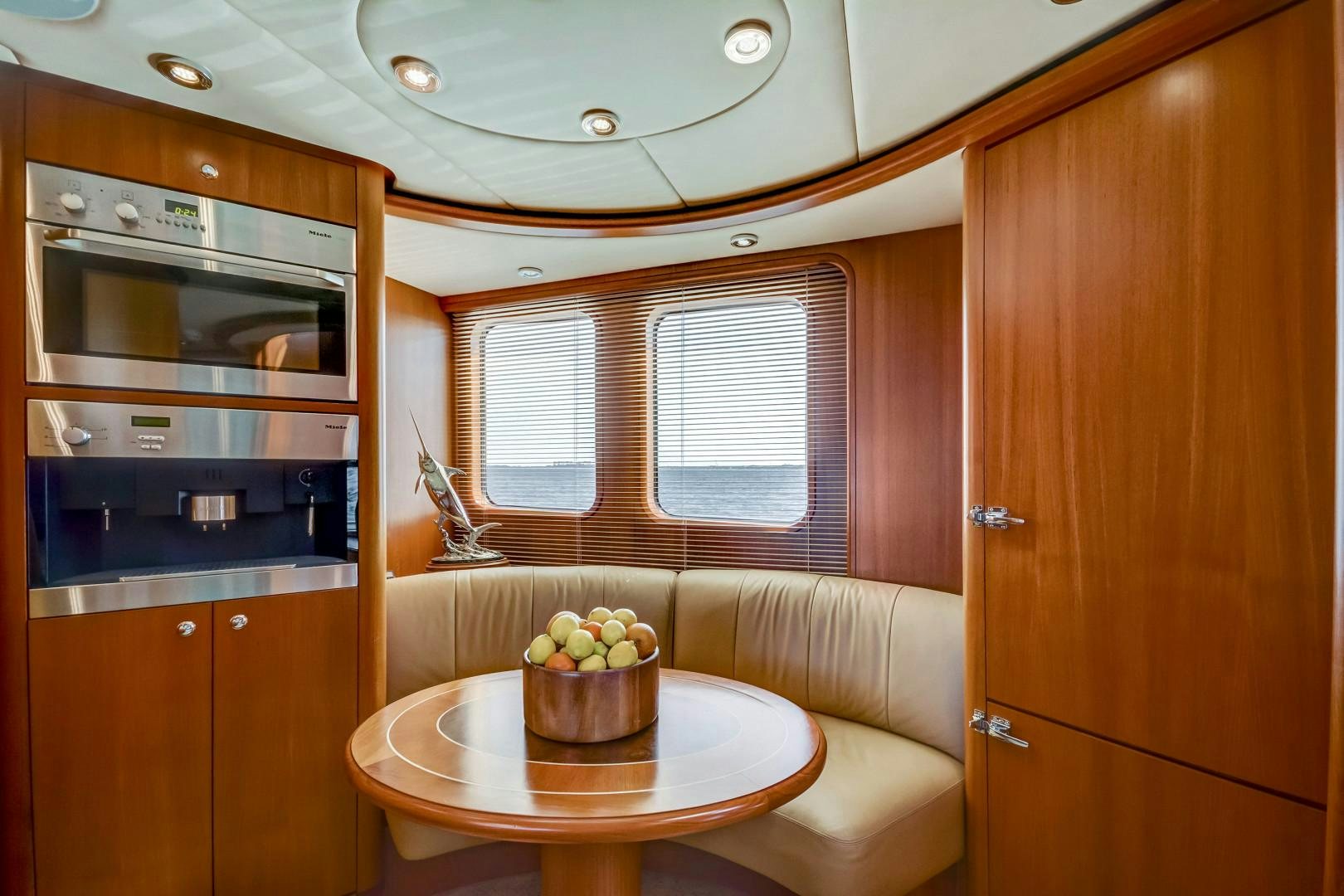 a kitchen with a table and a microwave aboard GUSTO Yacht for Sale
