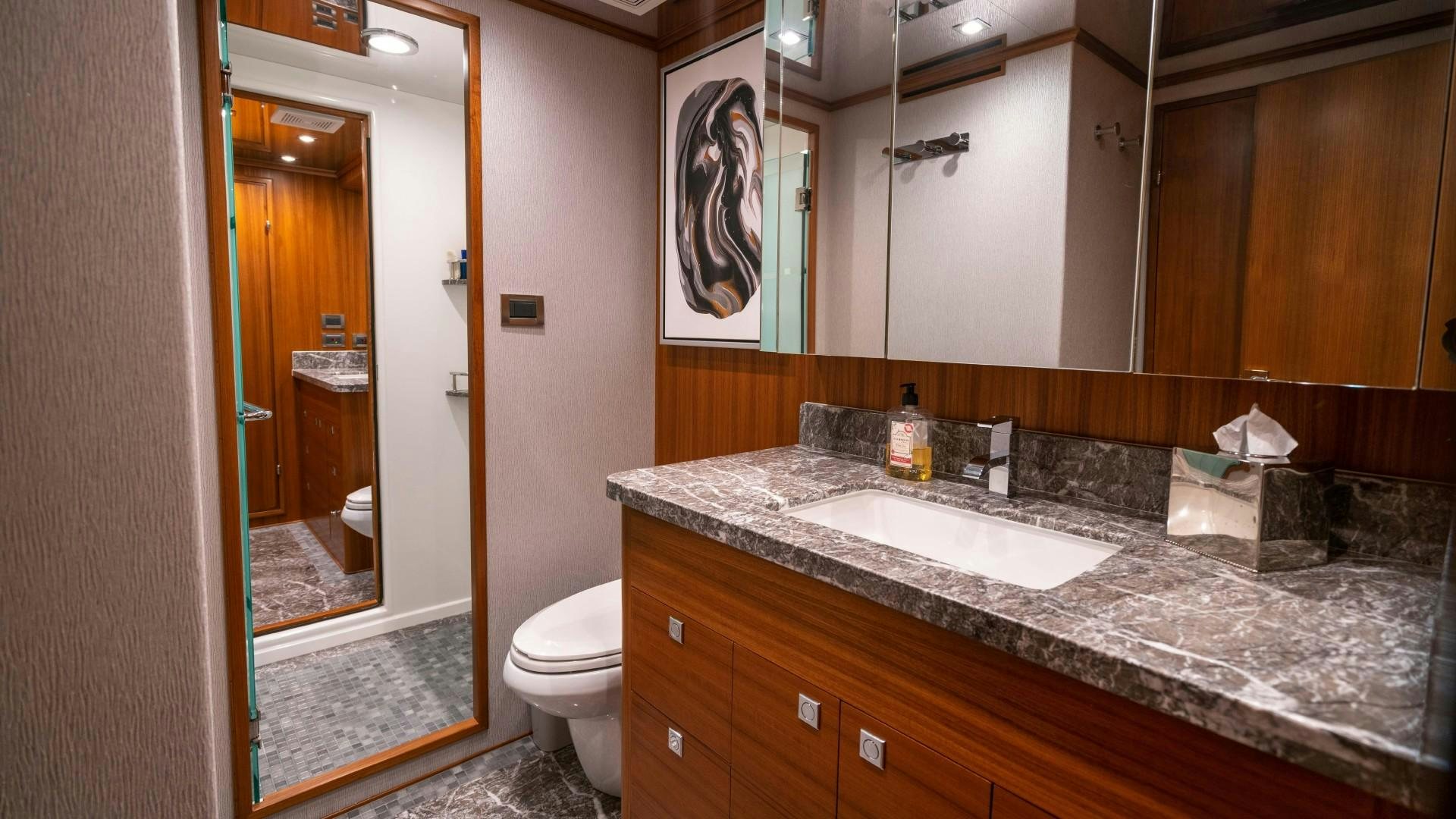 a bathroom with a countertop sink and a mirror aboard BLUE CHIP Yacht for Sale