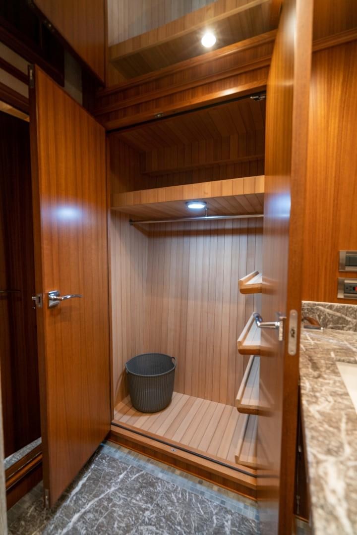 a bathroom with a wood door aboard BLUE CHIP Yacht for Sale