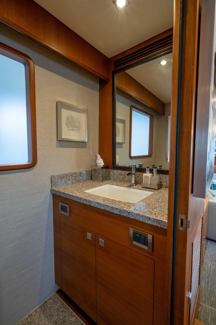a bathroom with a sink and a mirror aboard BLUE CHIP Yacht for Sale