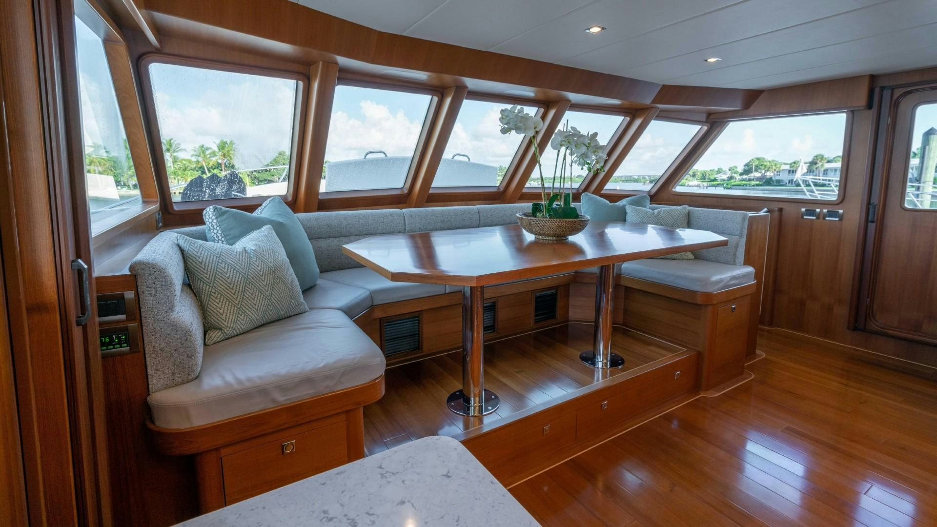 a room with a table and couch aboard BLUE CHIP Yacht for Sale