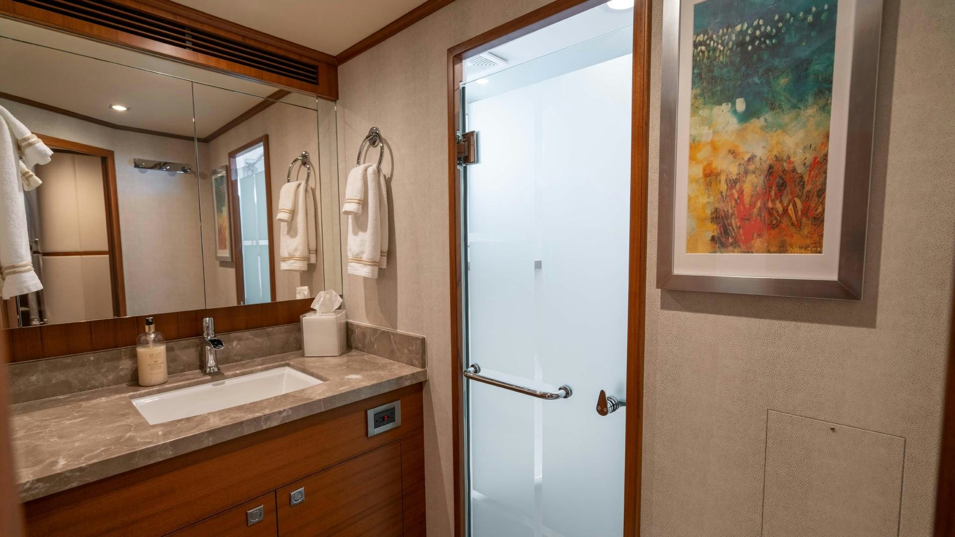 a bathroom with a large mirror aboard BLUE CHIP Yacht for Sale