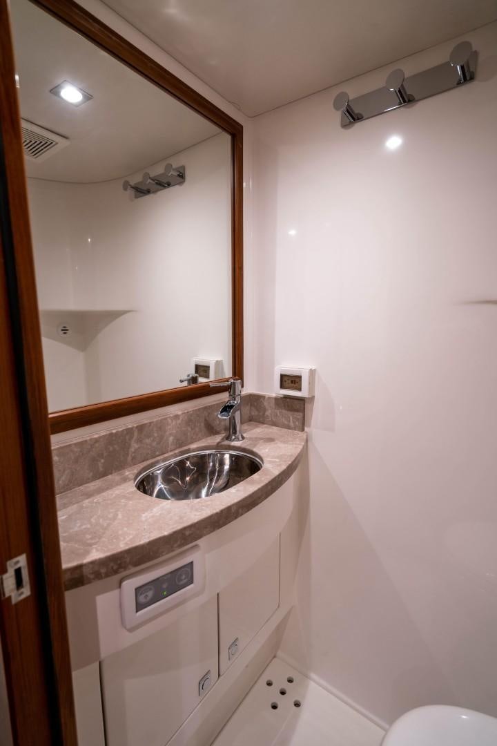 a bathroom with a sink and a mirror aboard BLUE CHIP Yacht for Sale