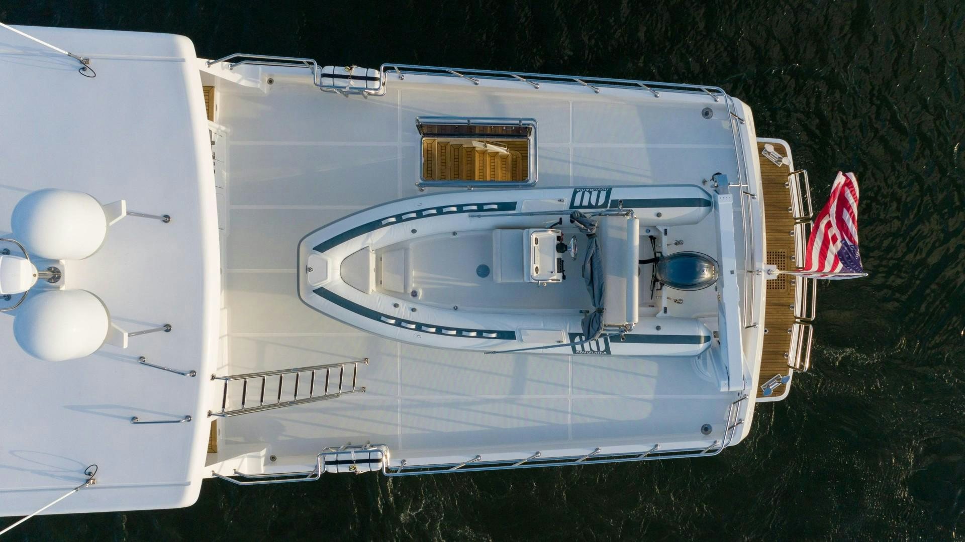 a white trailer with a flag on it aboard BLUE CHIP Yacht for Sale